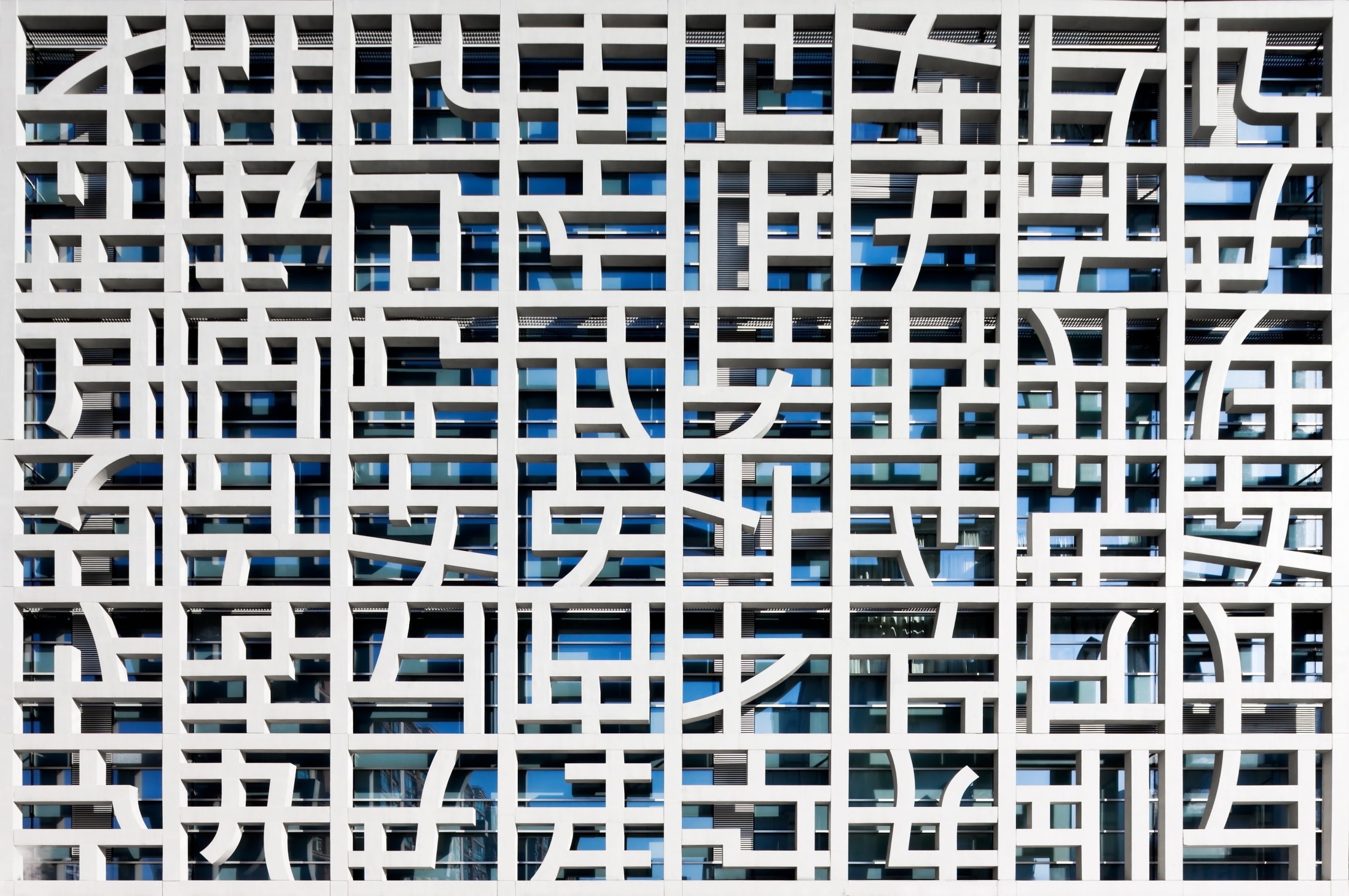 Modern building facade with geometric patterns and glass windows in Shanghai HD Wallpaper