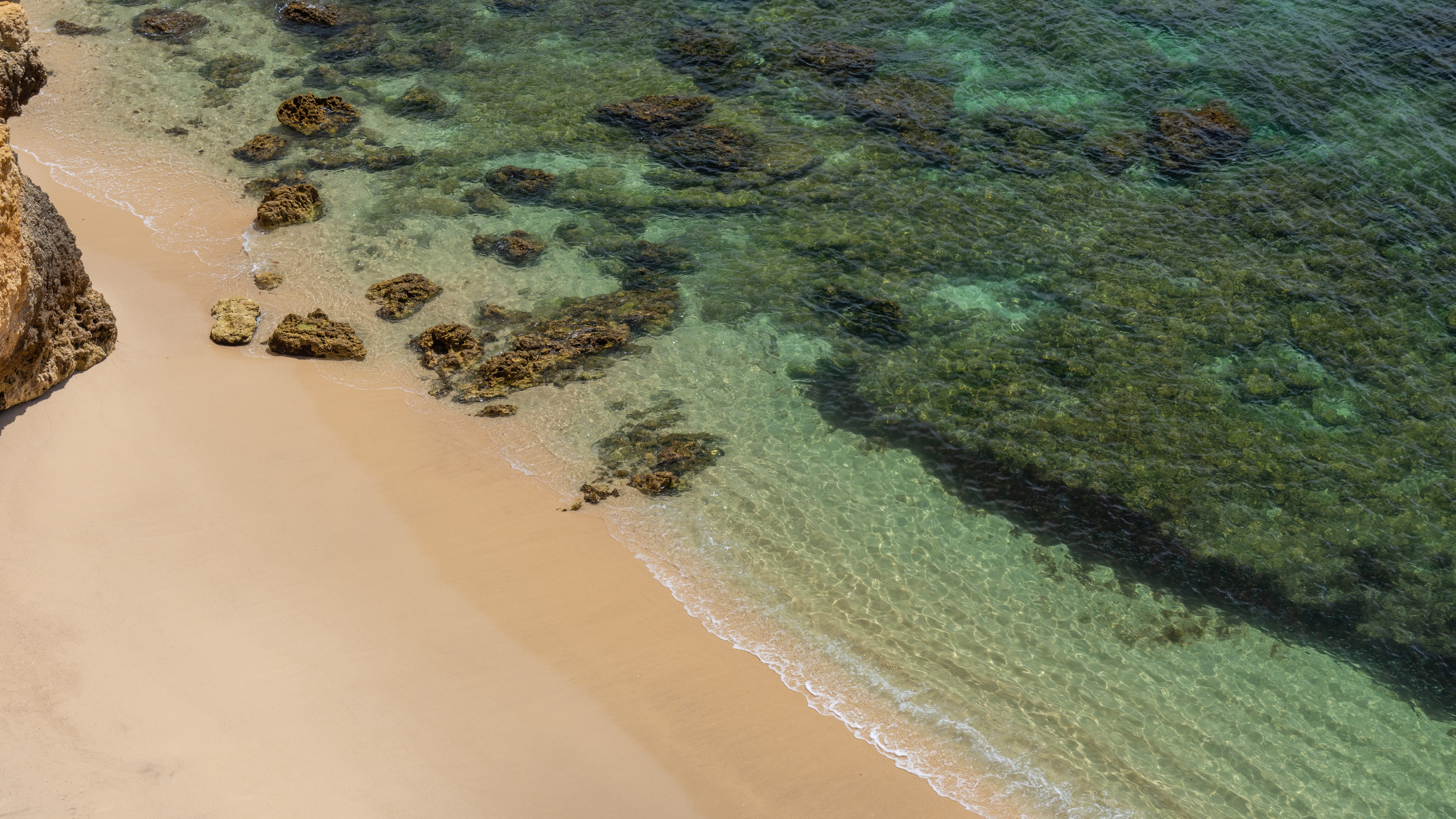 Beach and clear water with rocks in Algarve, Portugal HD Wallpaper