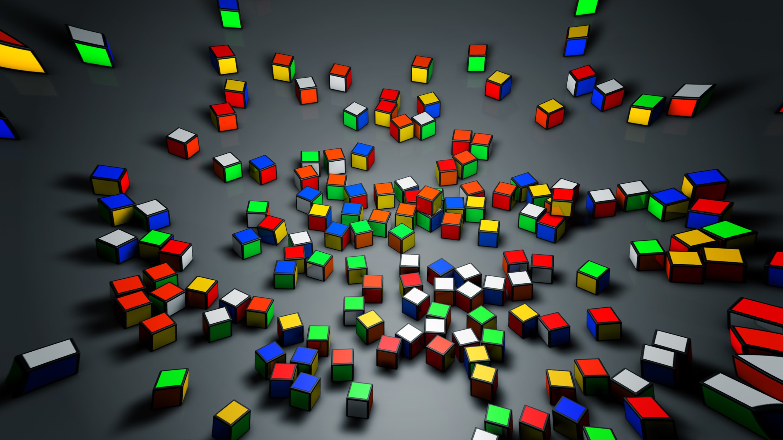 Scattered colorful Rubik's Cubes on a dark surface HD Wallpaper