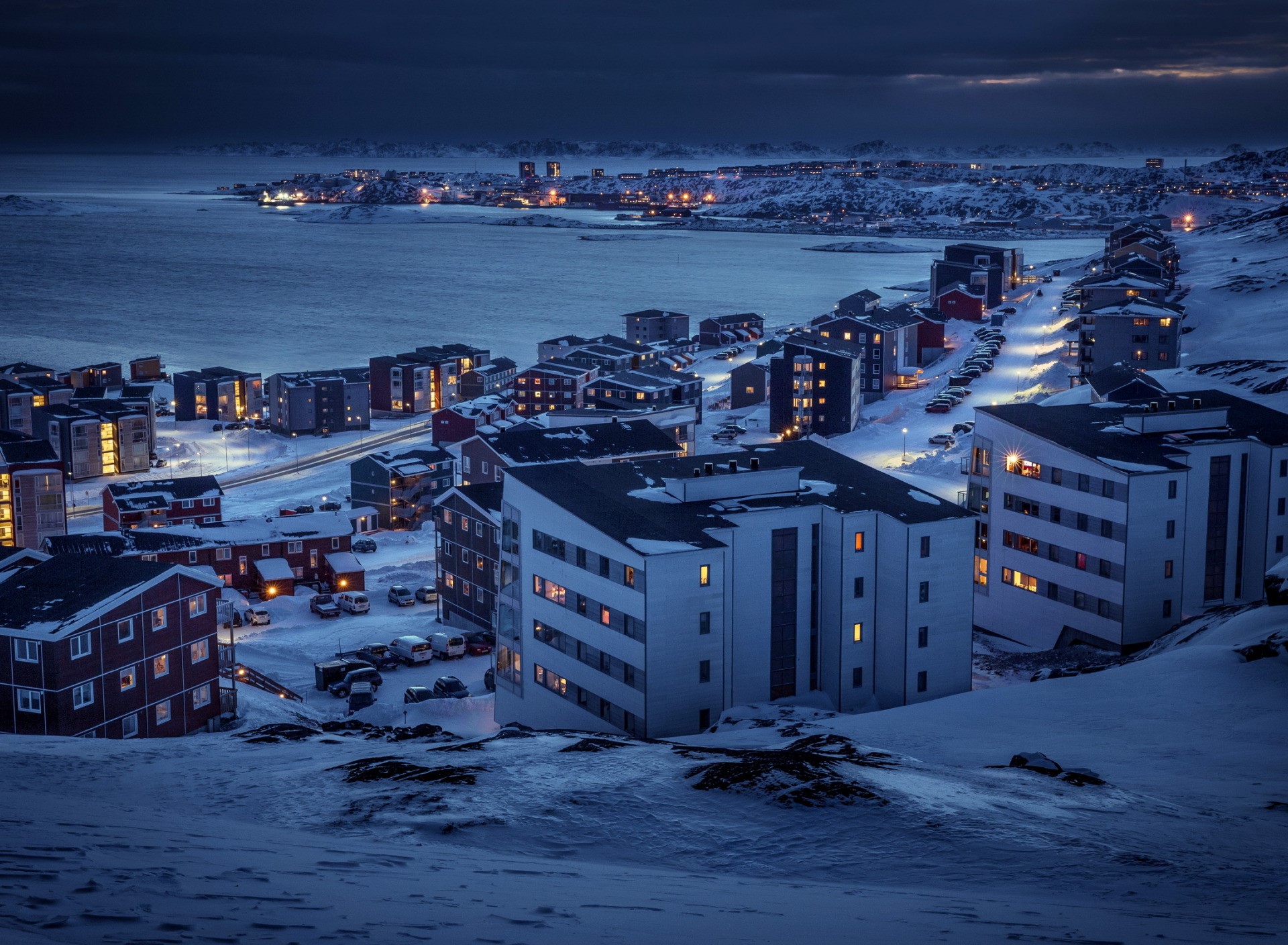 Snowy town at dusk by the water HD Wallpaper