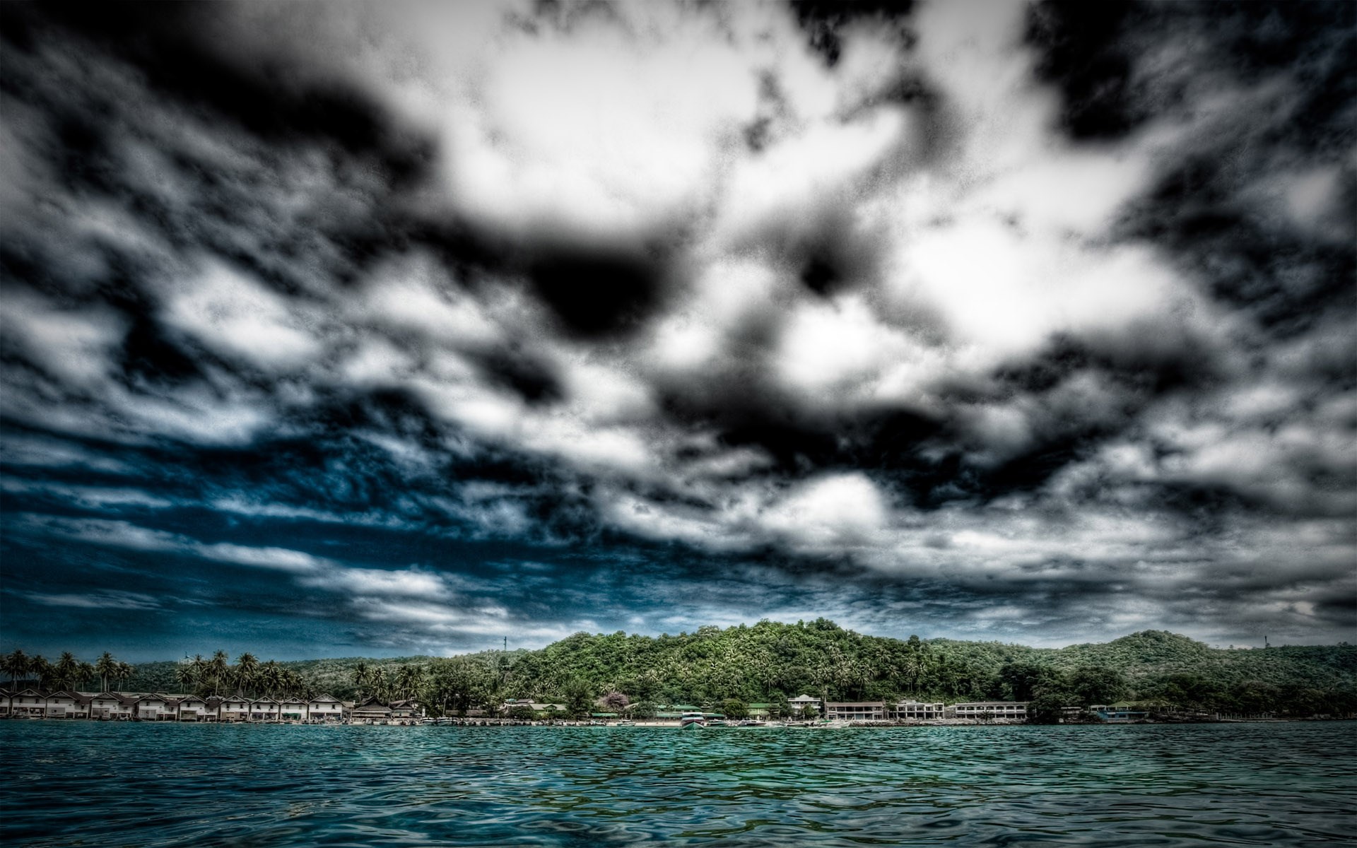 Stormy clouds over a tropical coastline with buildings HD Wallpaper