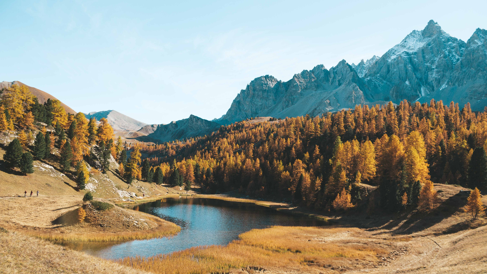 Autumn forest lake with mountains and hikers HD Wallpaper