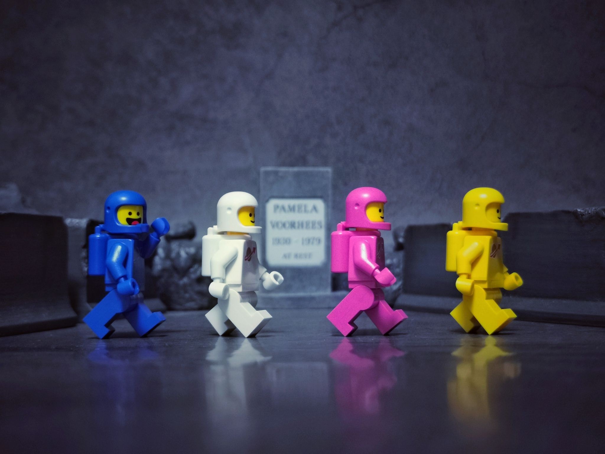Four Lego astronauts walk past a tombstone HD Wallpaper