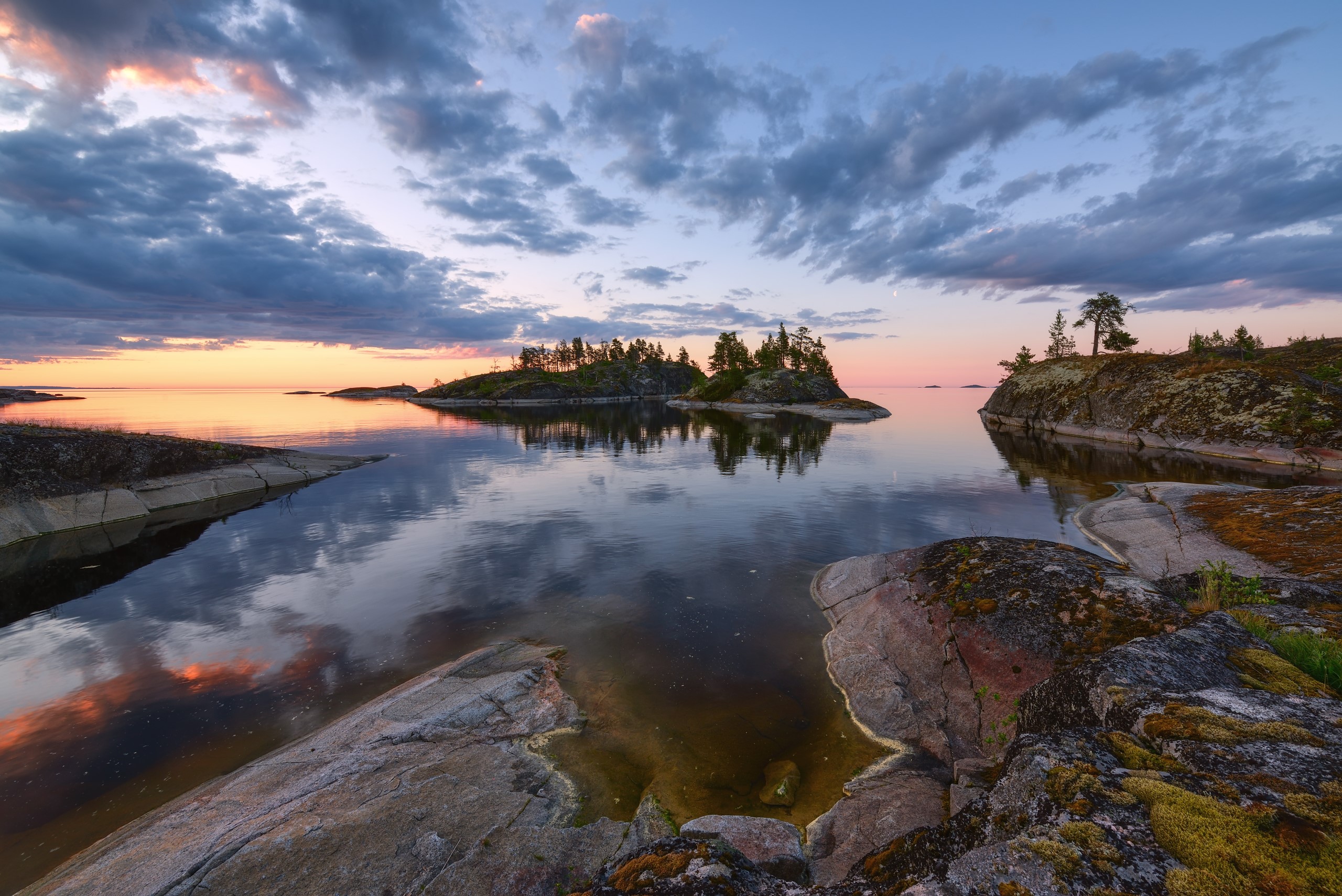Sunset over islands with reflections in water HD Wallpaper