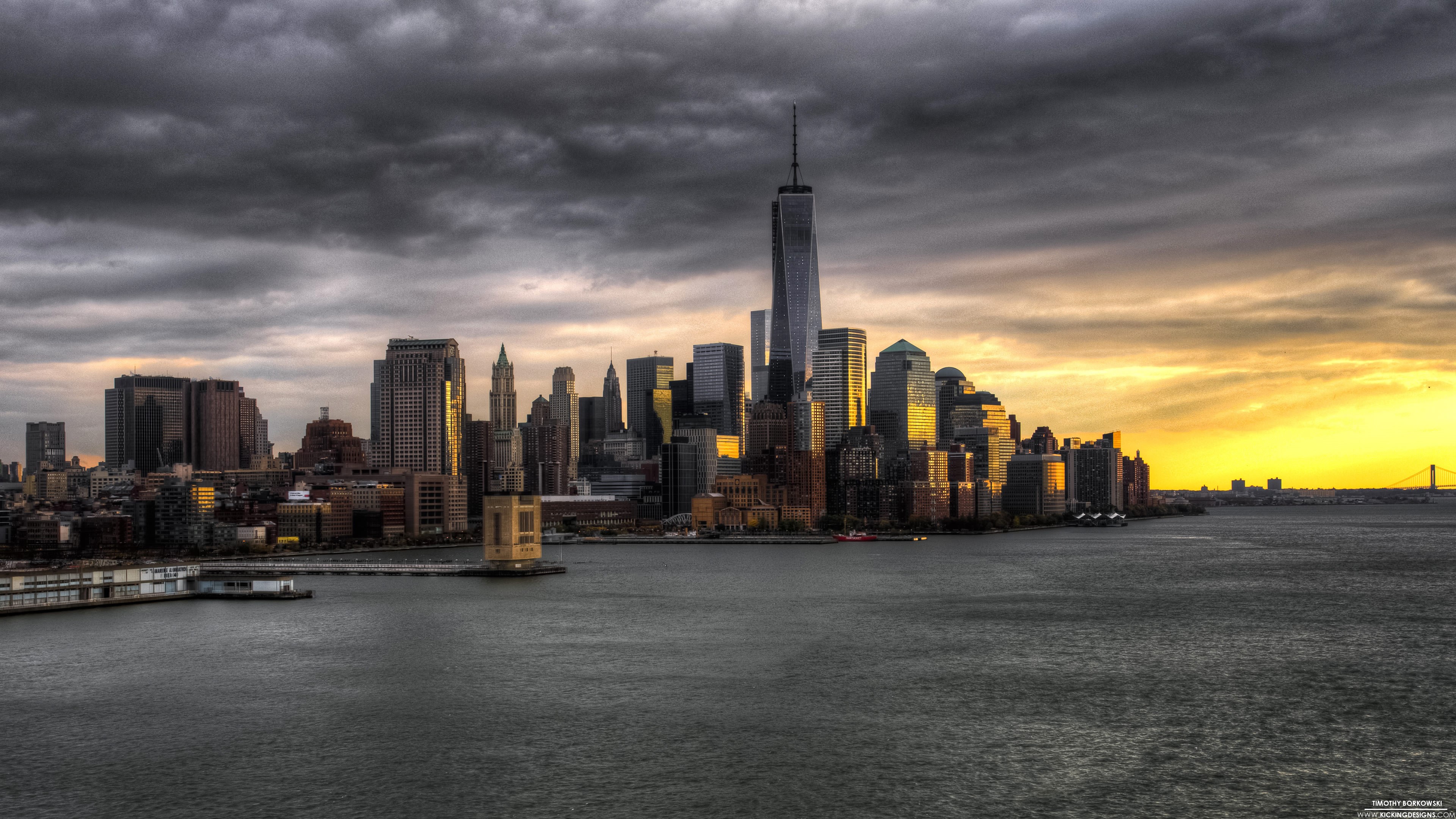 New York City skyline at sunset with storm clouds HD Wallpaper