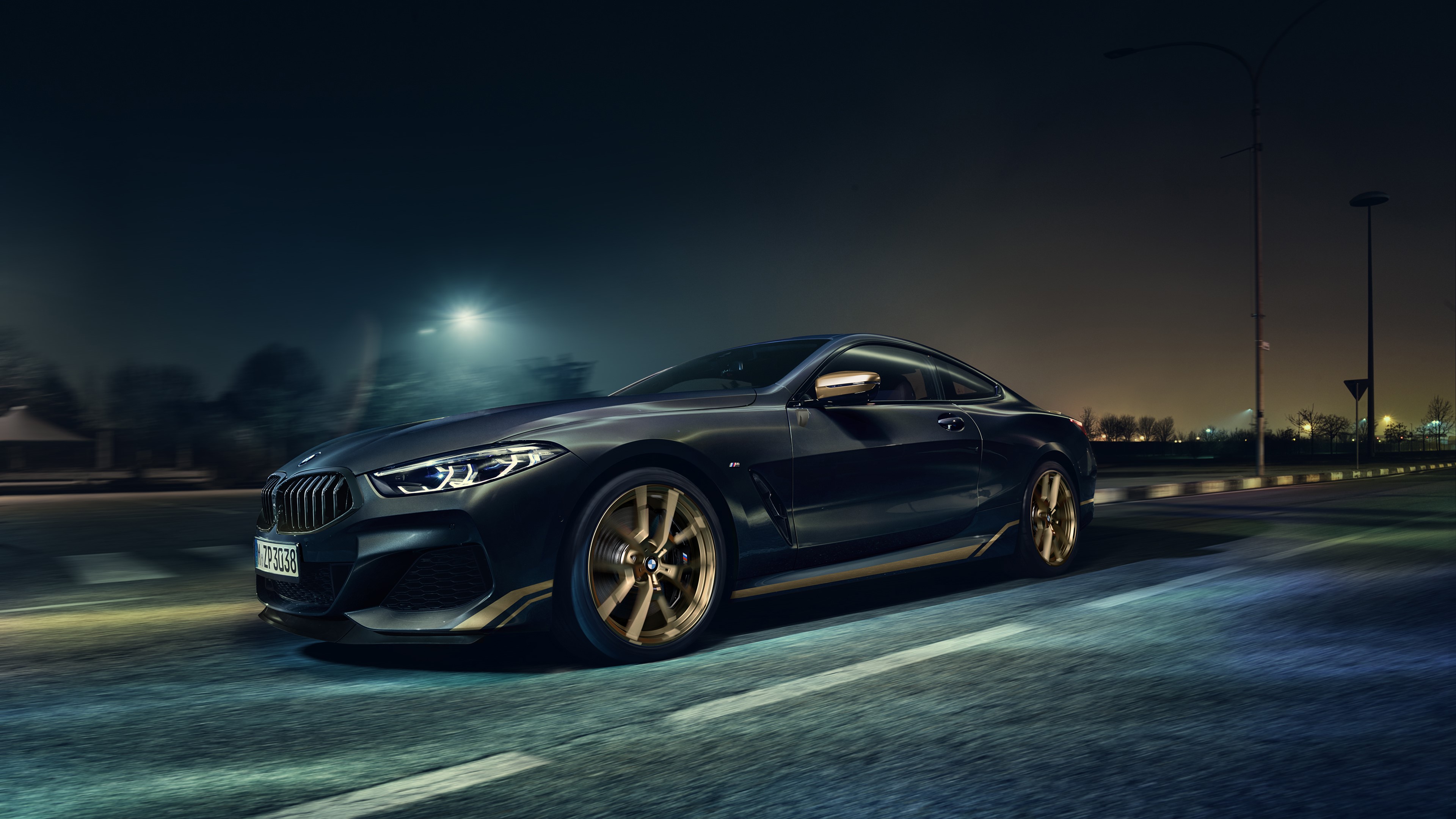 4K BMW M850i driving on a road at night HD Wallpaper