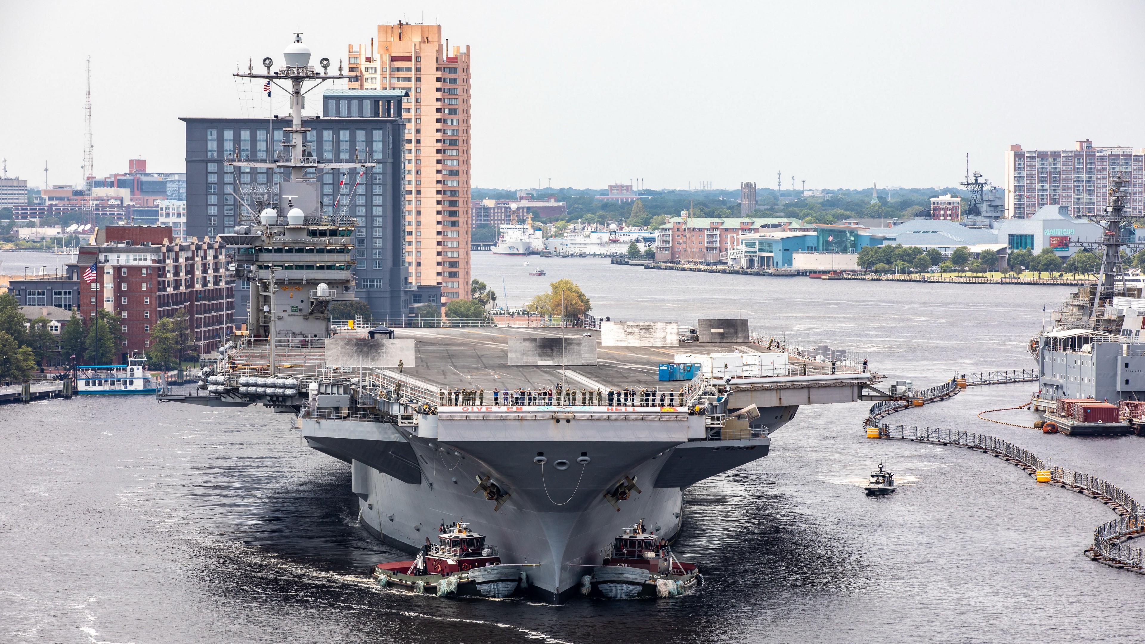 USS Harry S. Truman aircraft carrier in a harbor HD Wallpaper