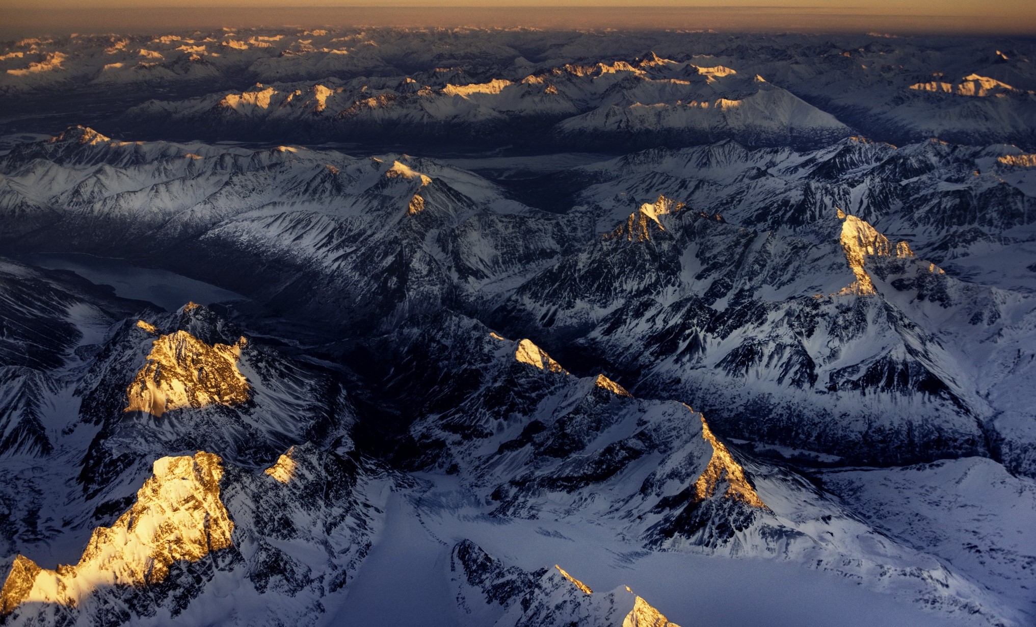 Aerial view of snow-covered mountains in Alaska at sunset HD Wallpaper
