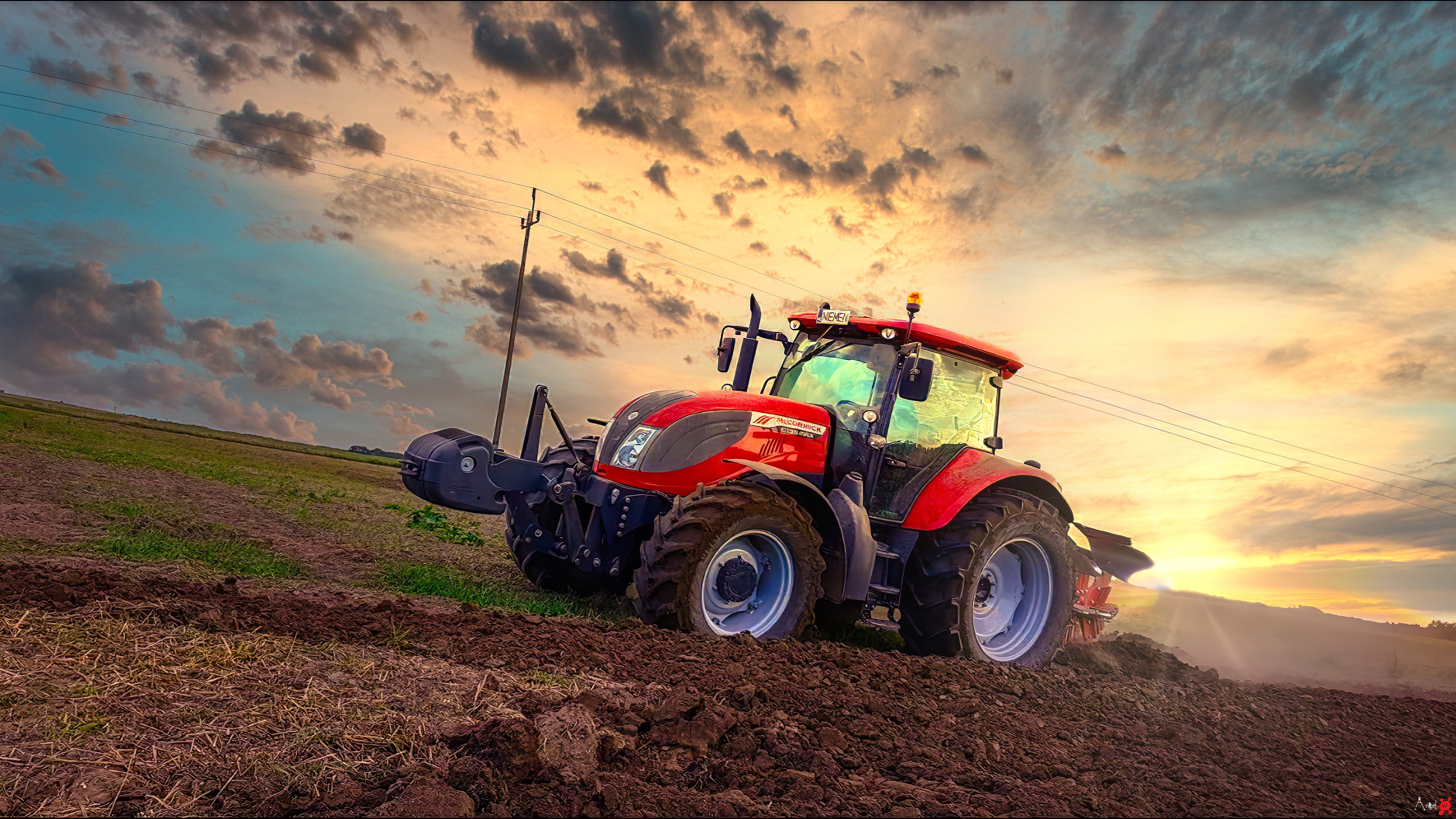 Red McCormick tractor plowing a field at sunset HD Wallpaper