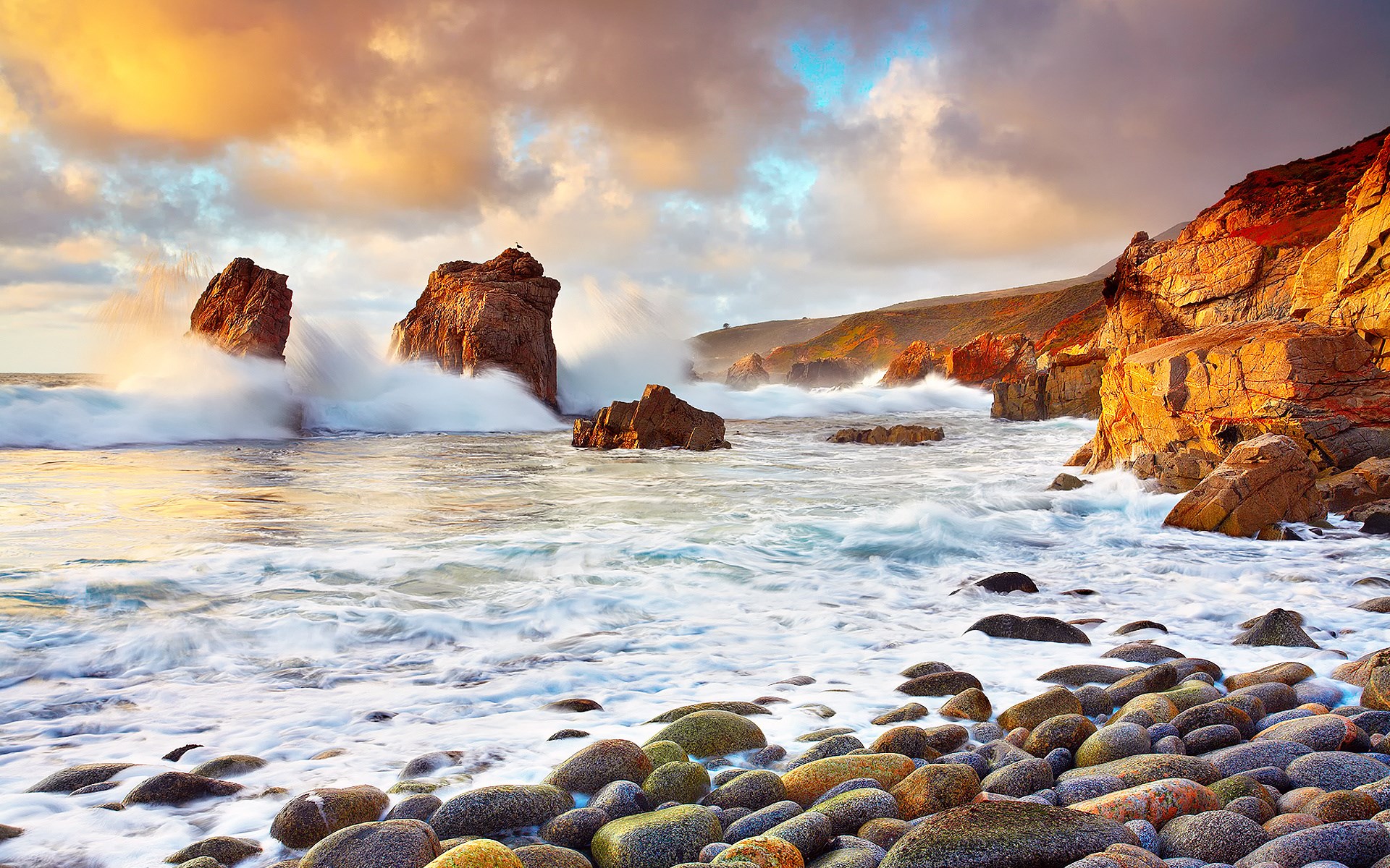 Waves crashing on rocky shore at sunset HD Wallpaper