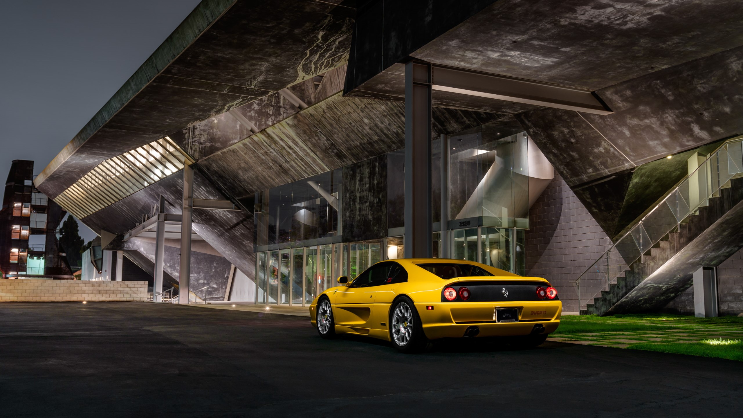 Yellow Ferrari F355 parked at modern building at night HD Wallpaper