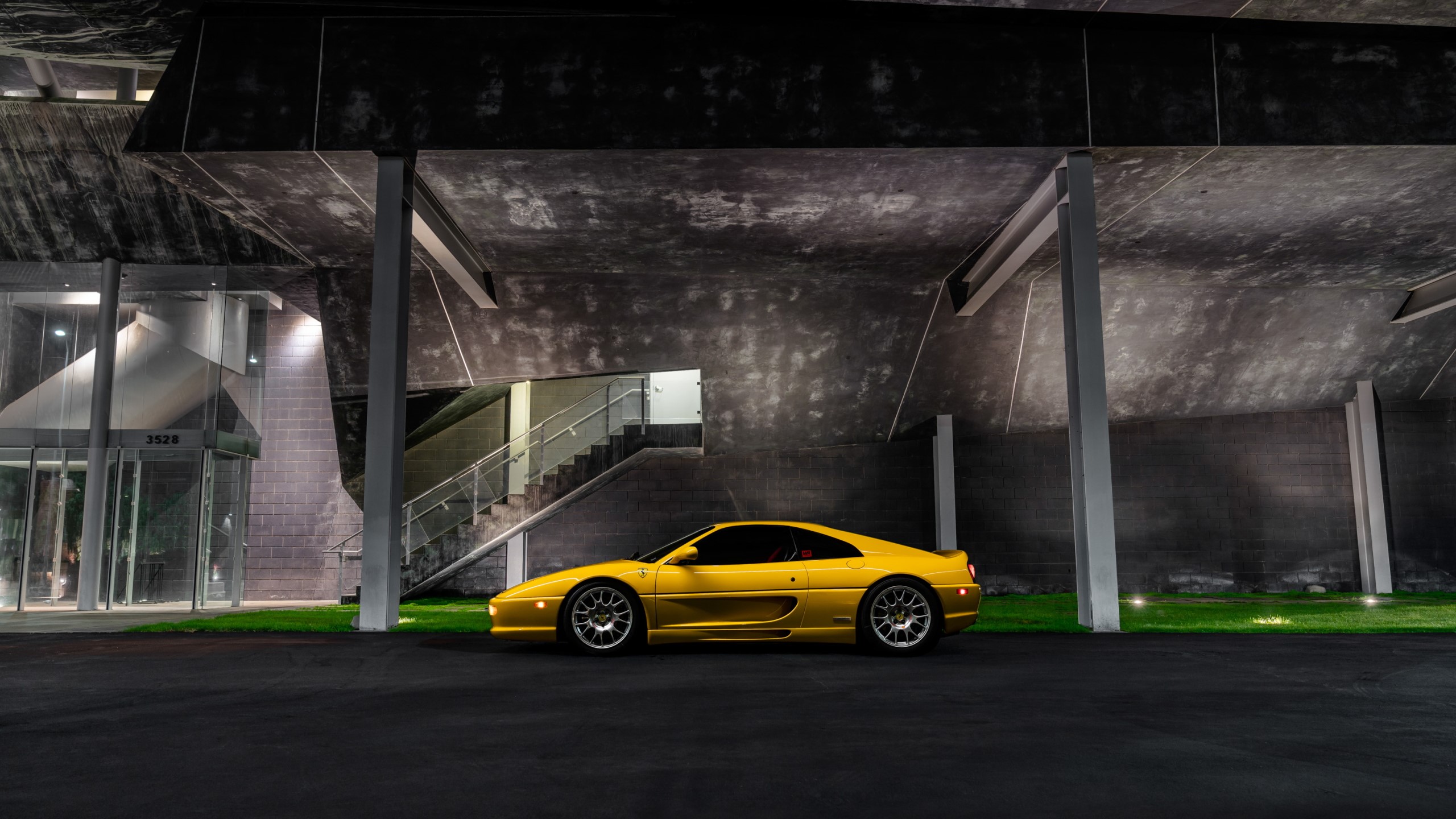 Yellow Ferrari F355 parked at modern building at night HD Wallpaper