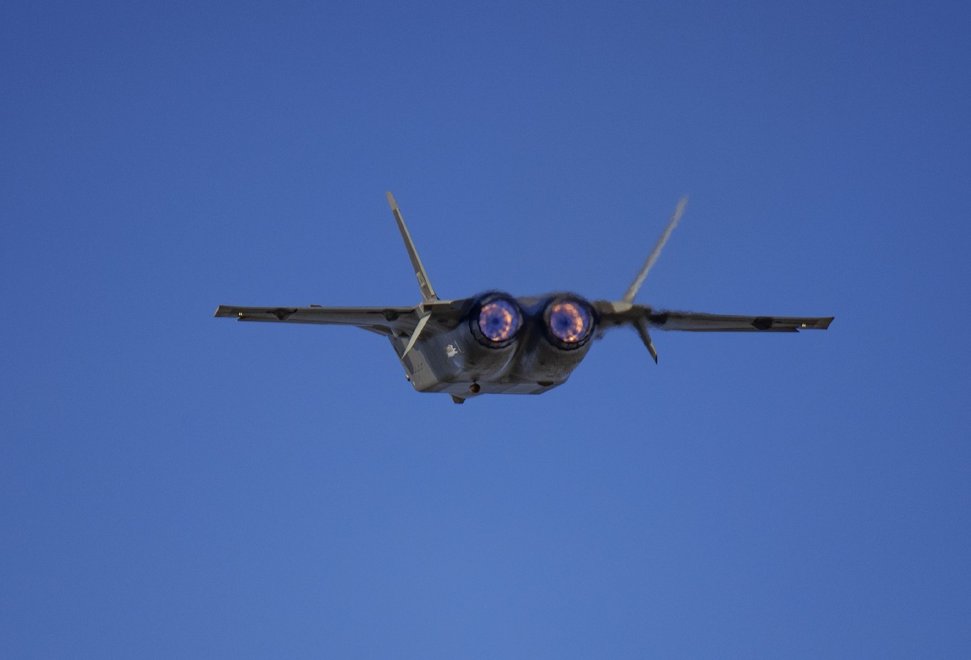 Rear view of a J-20 fighter jet in flight HD Wallpaper
