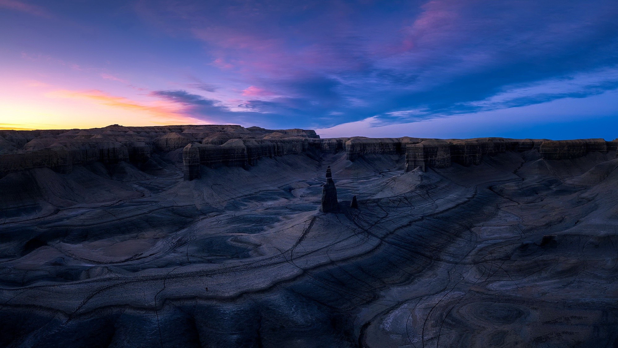 Dark desert landscape with rock formations at sunset HD Wallpaper