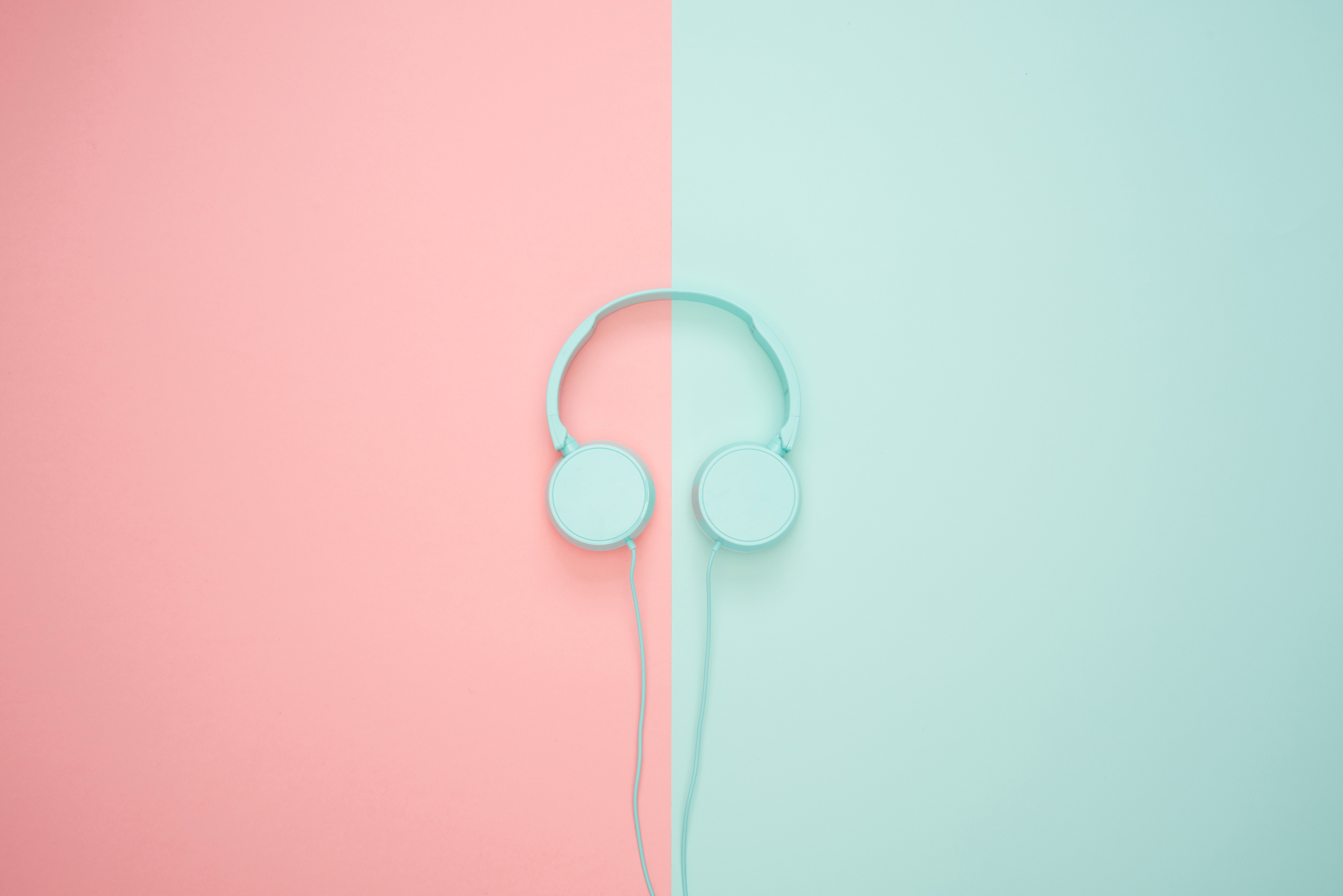 Light blue headphones on pink and teal background HD Wallpaper
