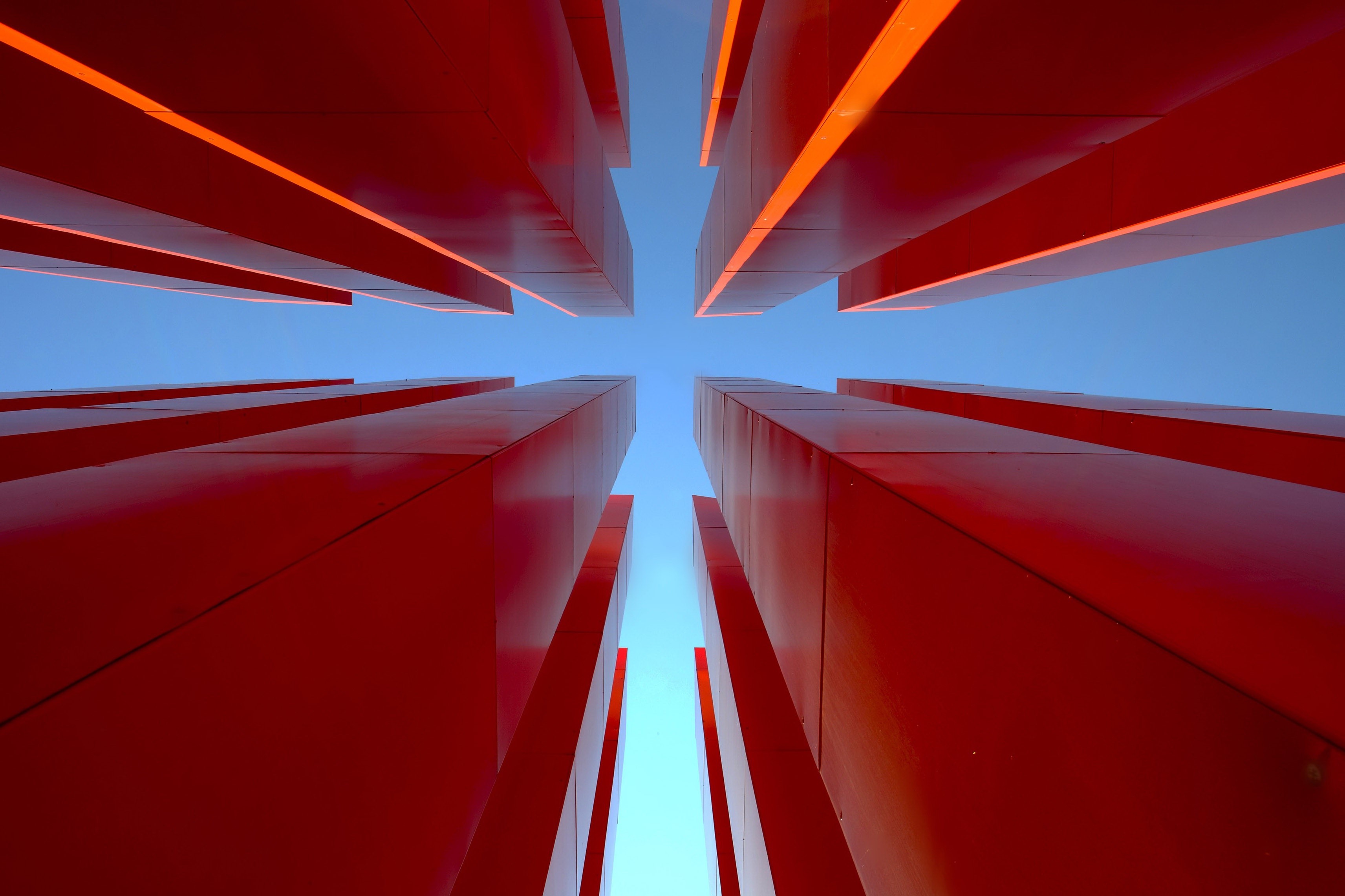 Red structures against a blue sky, worm's eye view HD Wallpaper
