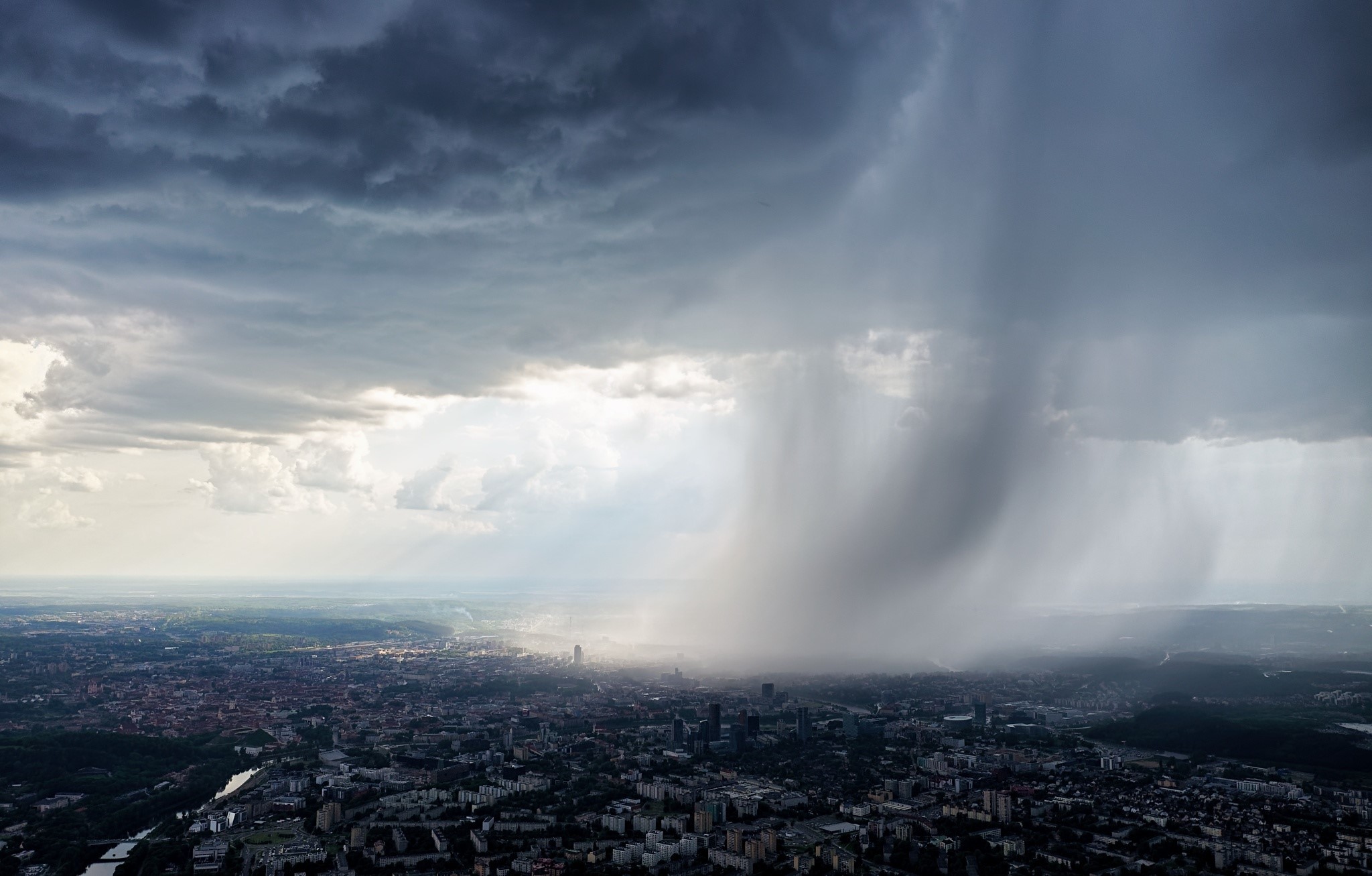 Vilnius cityscape under a stormy sky with rain HD Wallpaper