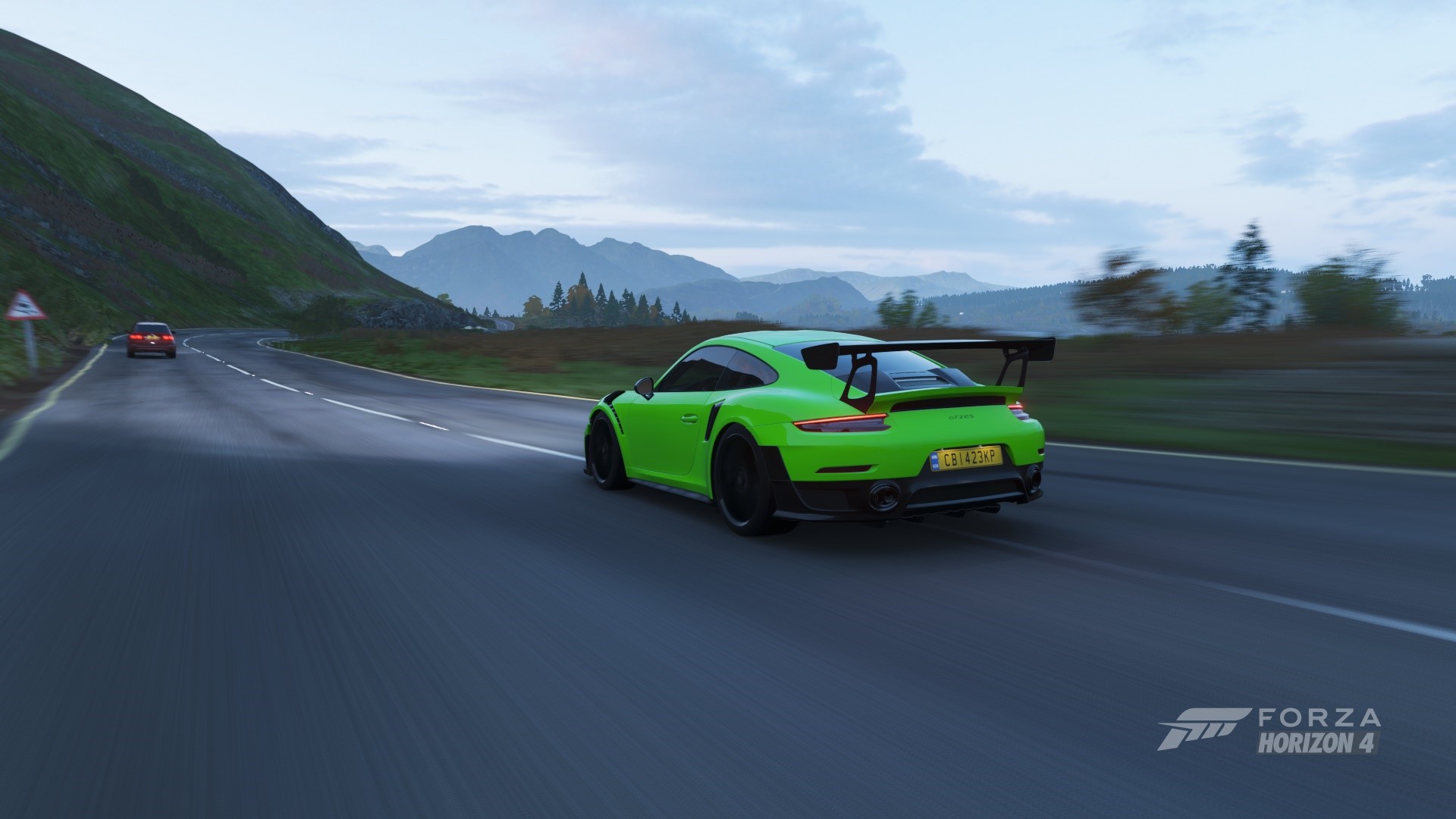 Green Porsche 911 GT2 RS driving on a road in Forza Horizon 4 HD Wallpaper