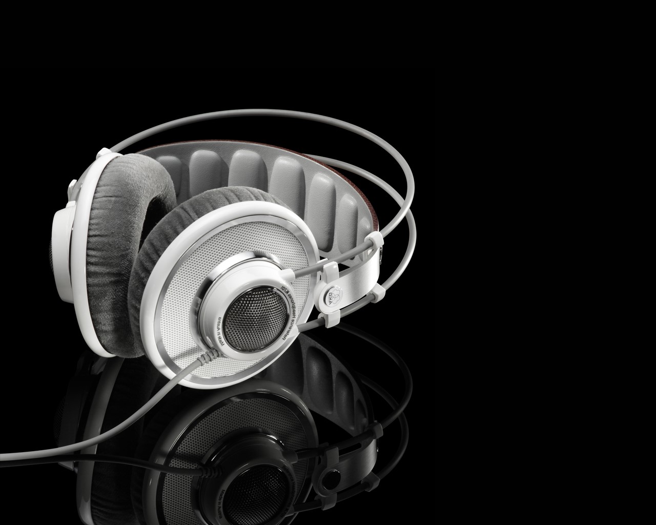 AKG headphones on a black reflective surface HD Wallpaper