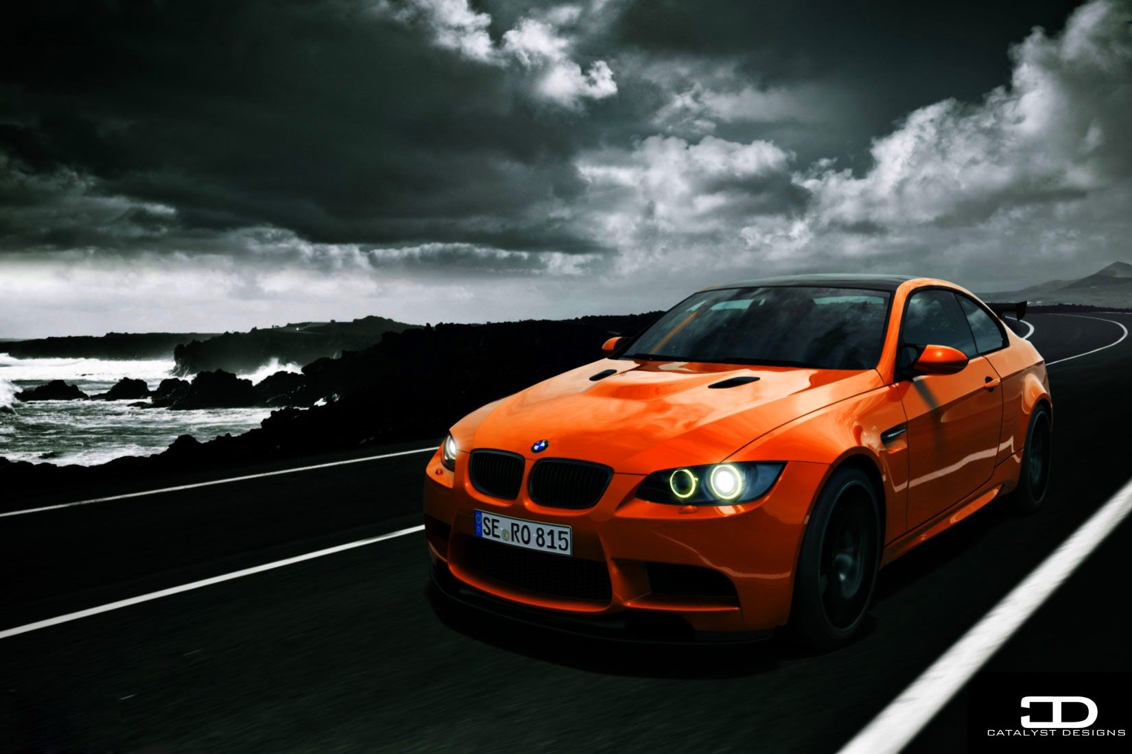 Orange BMW M3 Coupe on a Coastal Road HD Wallpaper
