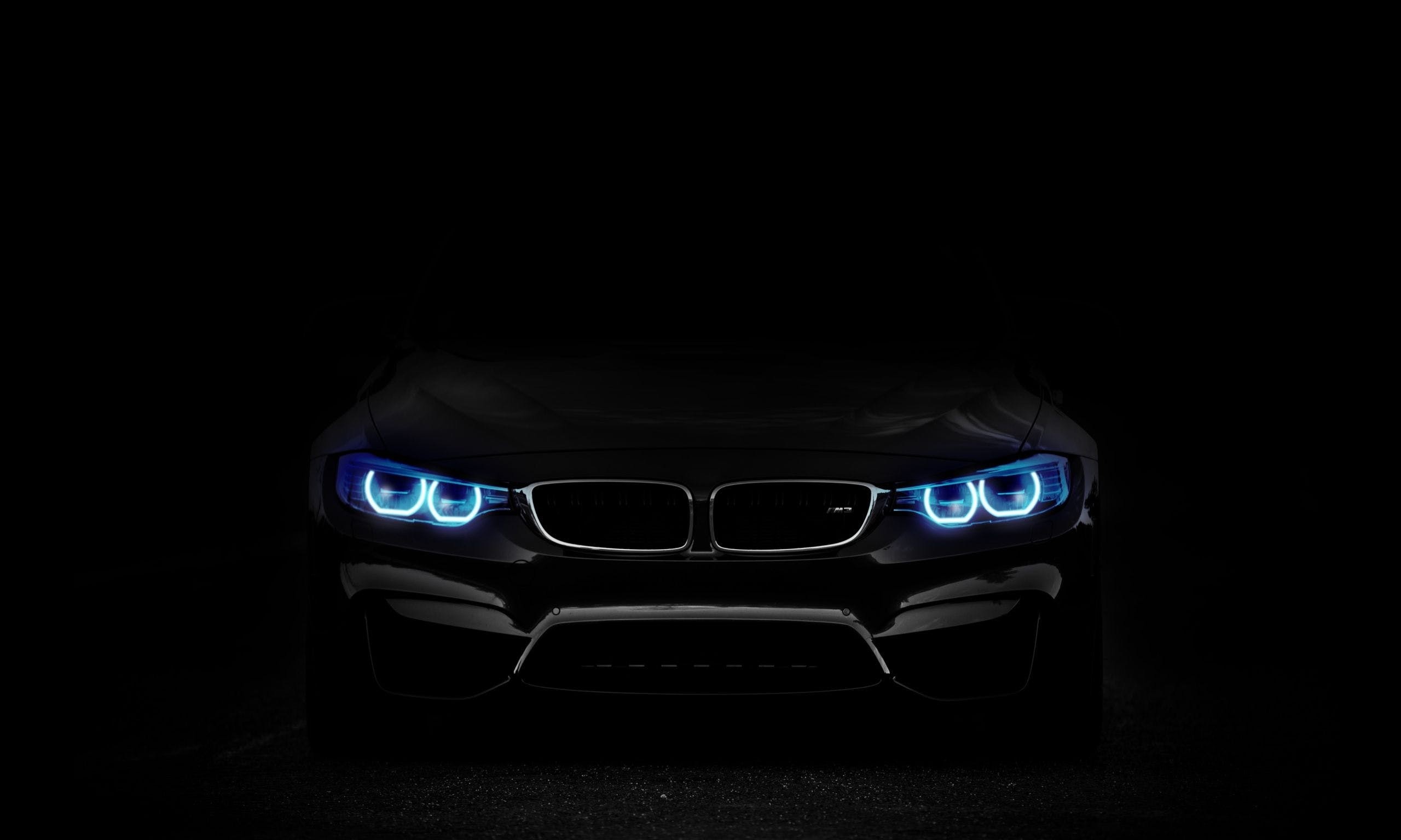 Black BMW M4 with blue headlights HD Wallpaper