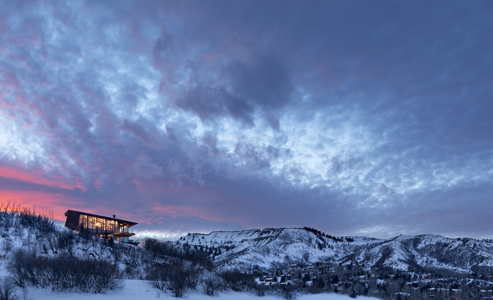 Modern house on a snowy mountain at sunset HD Wallpaper