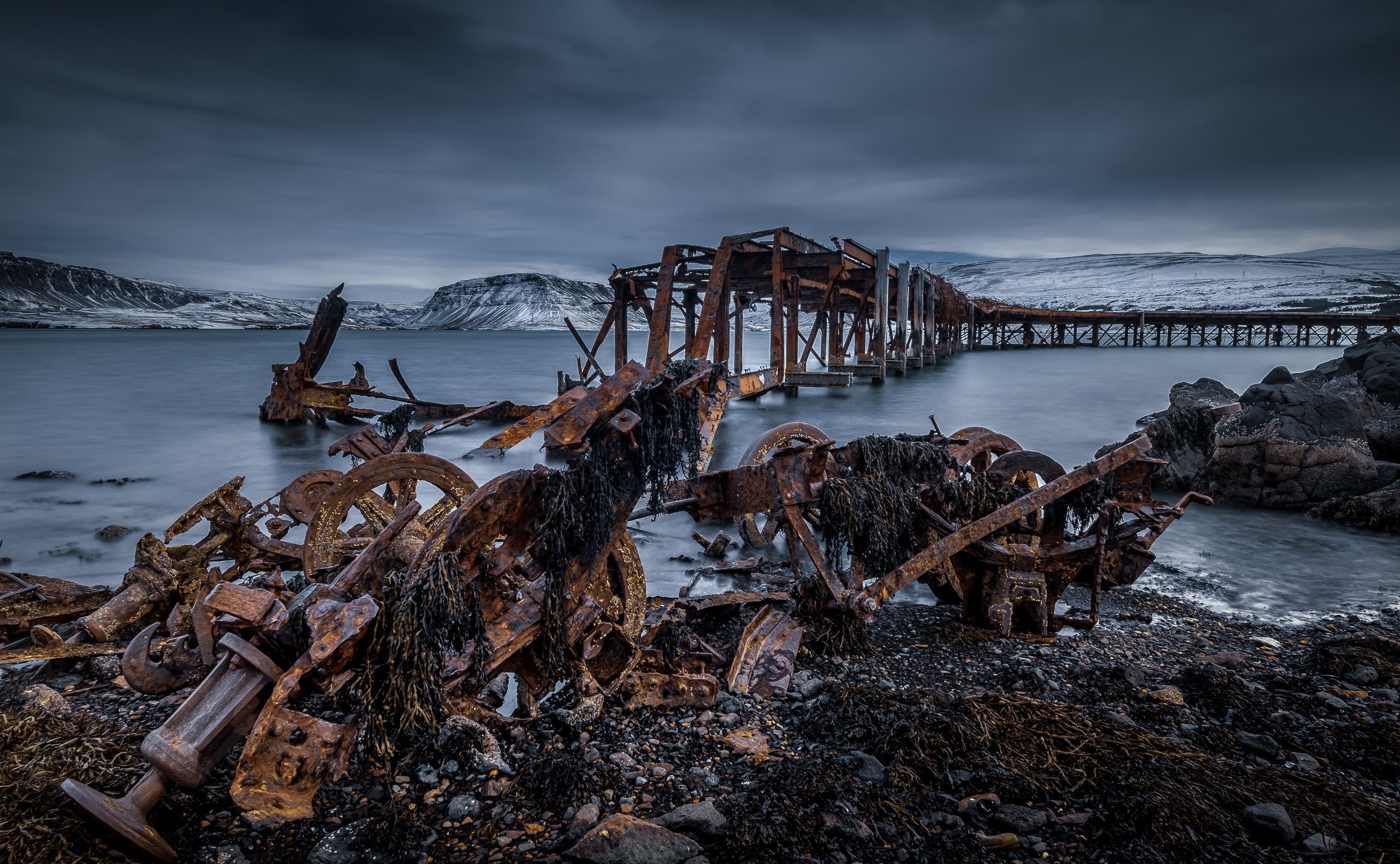 Rusty shipwreck and pier in Iceland HD Wallpaper