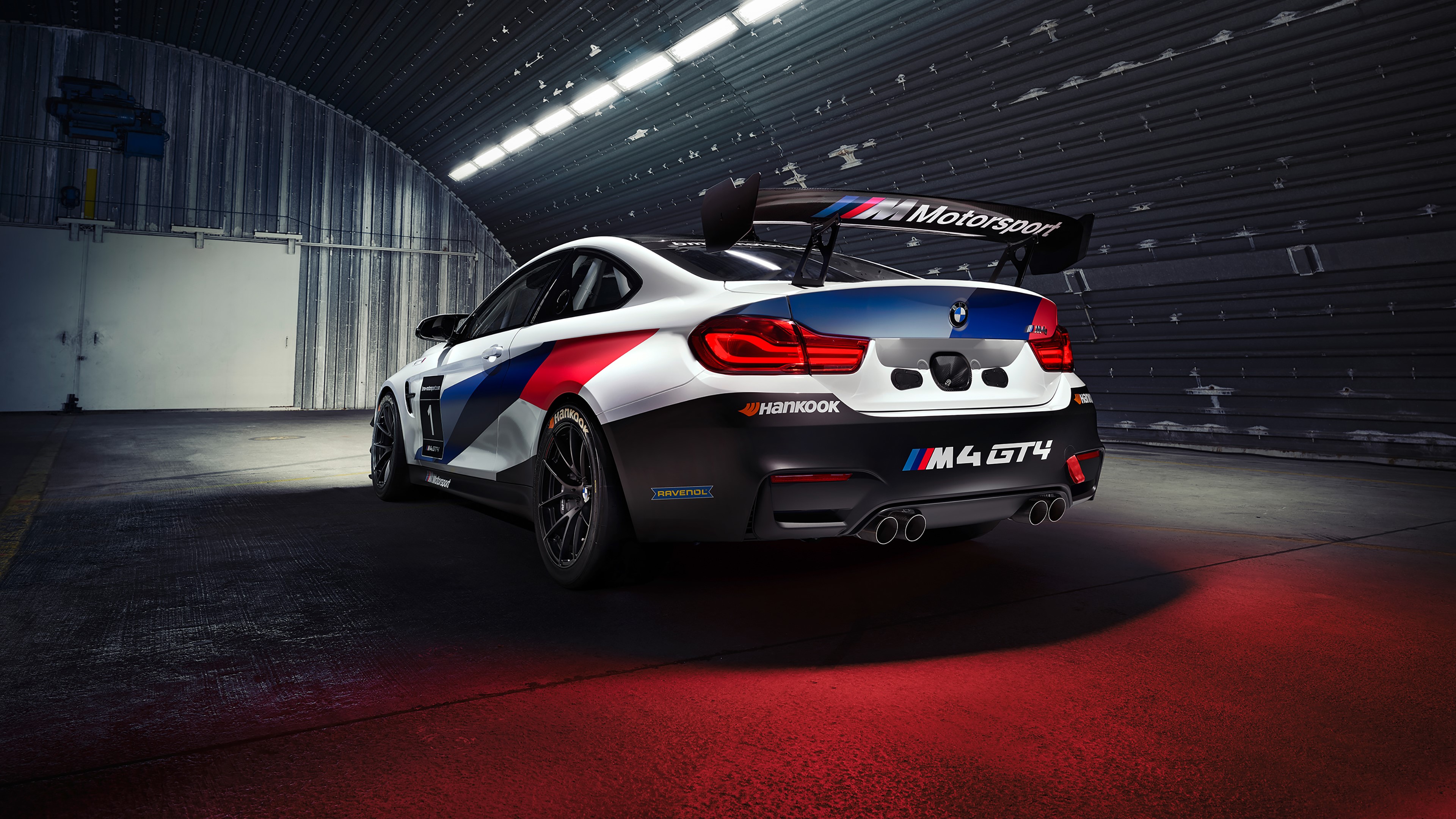 BMW M4 GT4 race car in hangar HD Wallpaper