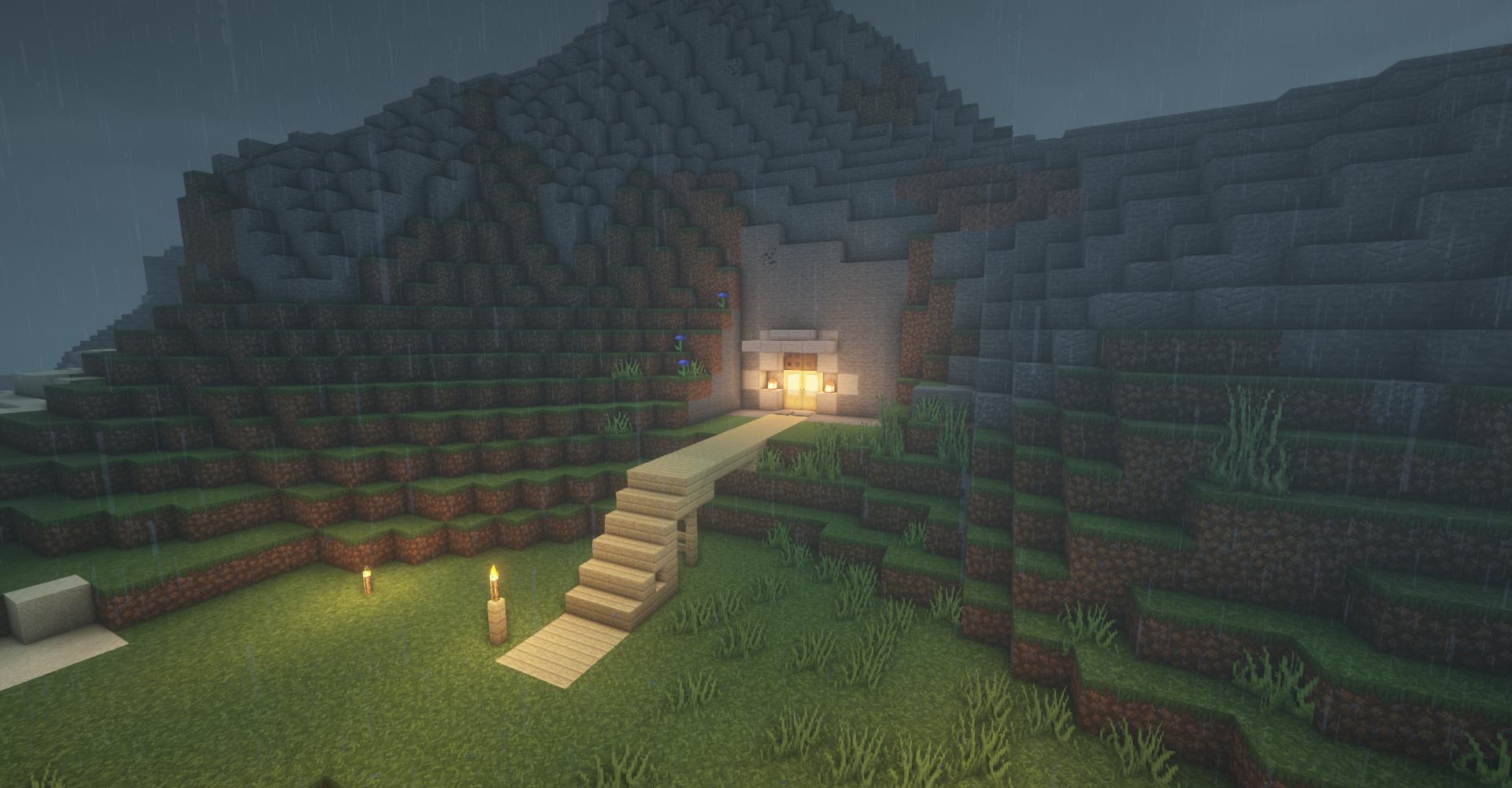 Minecraft screenshot of a mountain cave entrance during rain HD Wallpaper