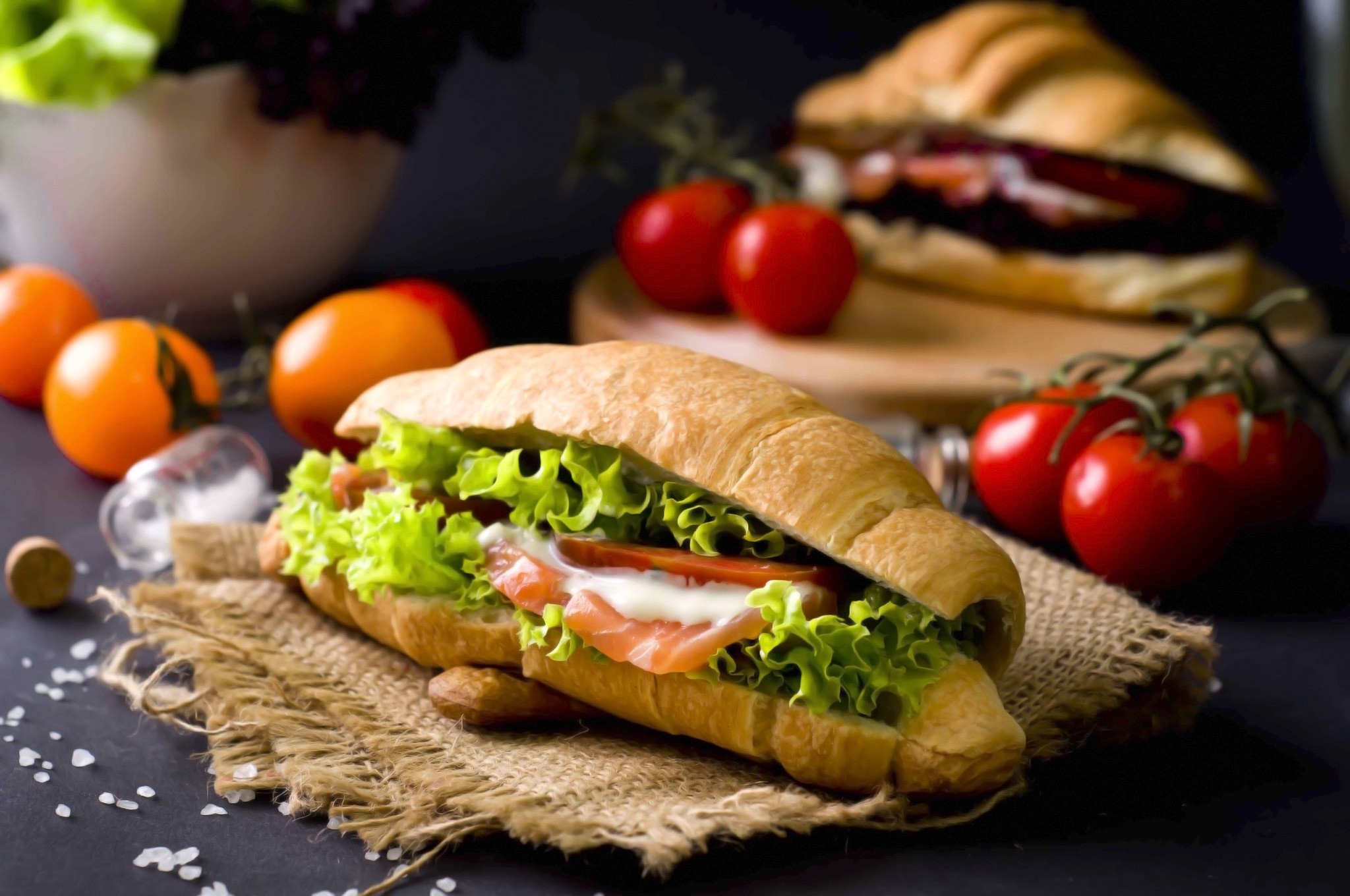 Croissant sandwich with salmon, lettuce, and tomatoes HD Wallpaper