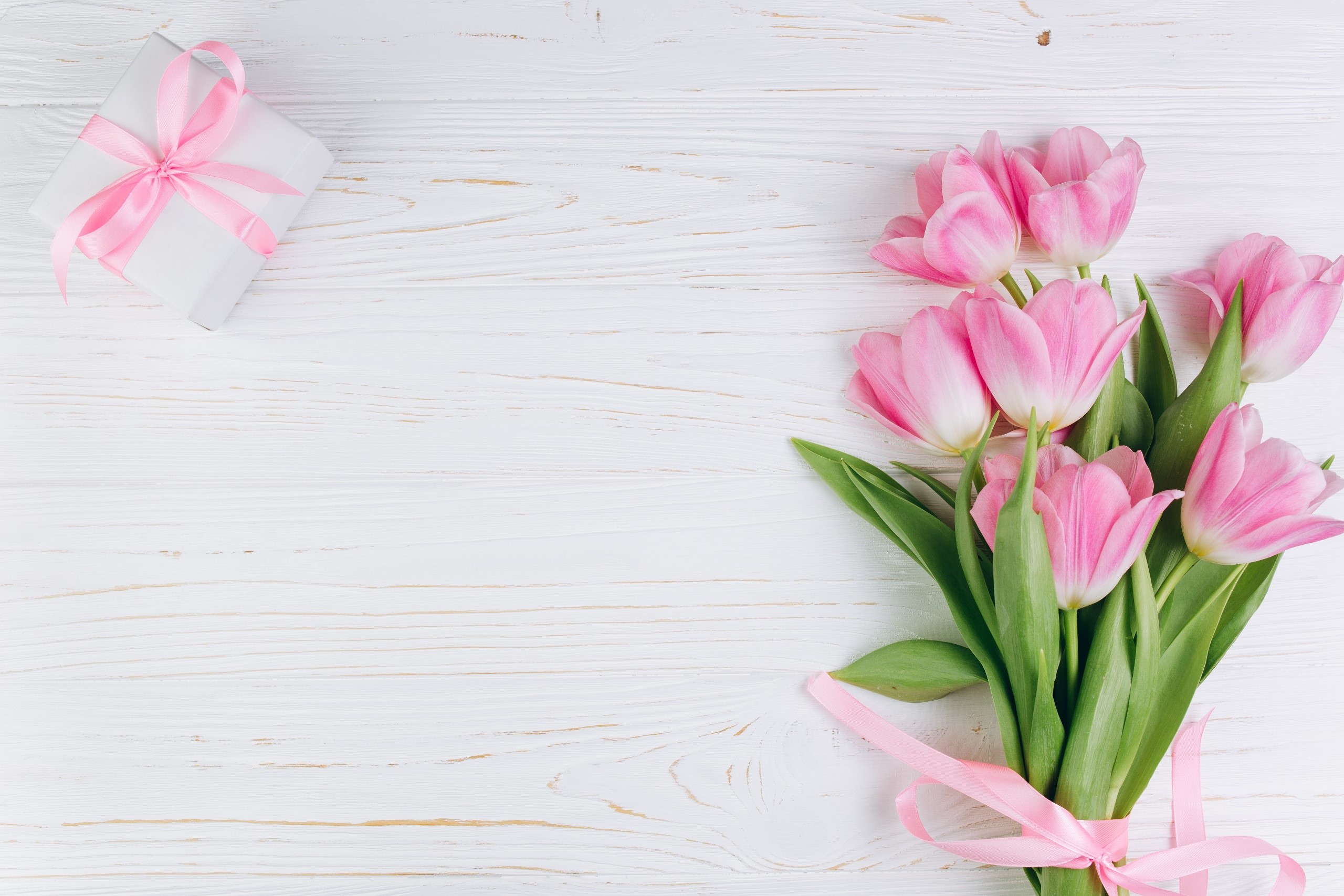 Pink tulips and a gift box on a white wooden table HD Wallpaper