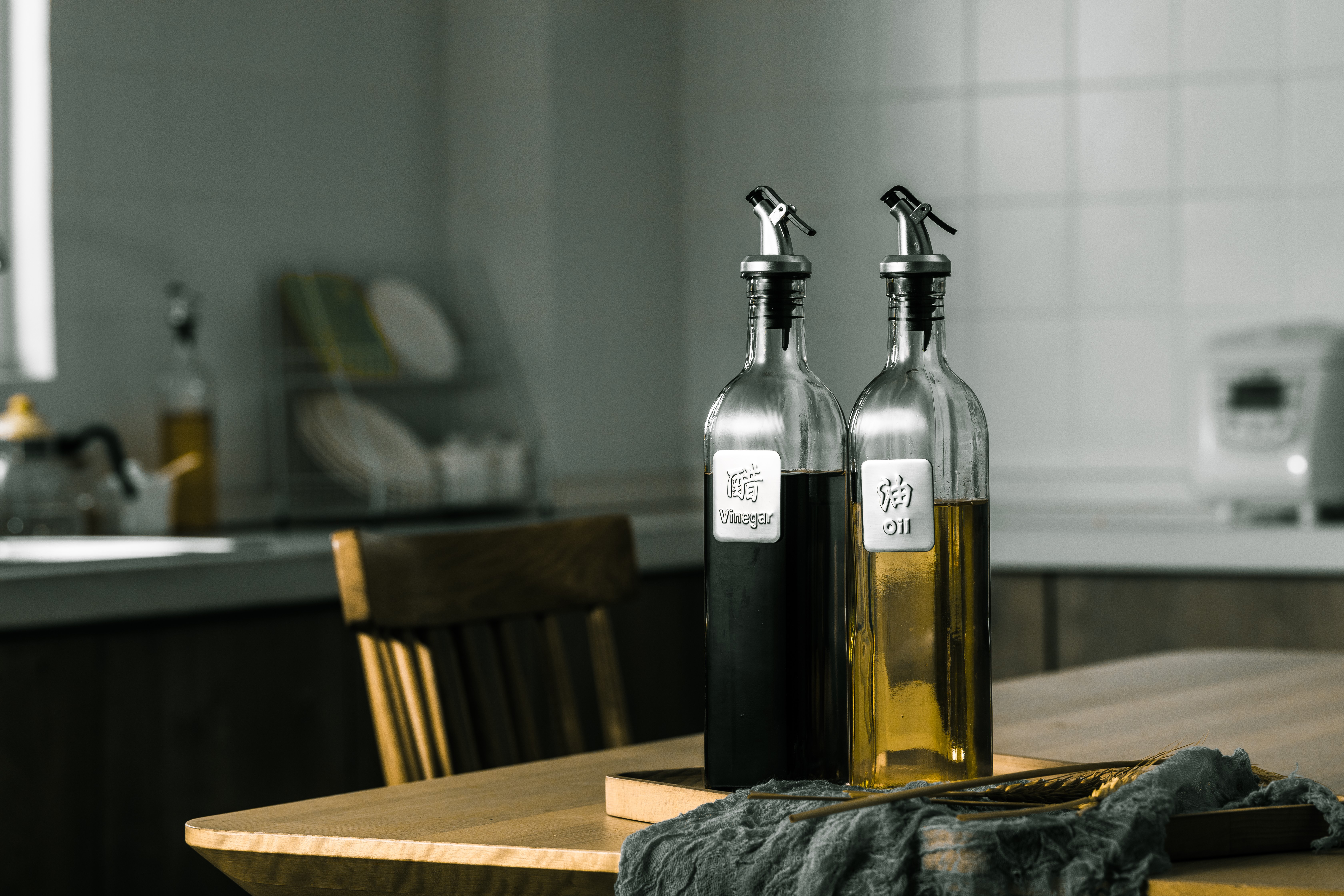 Two glass bottles of oil and vinegar in a kitchen HD Wallpaper