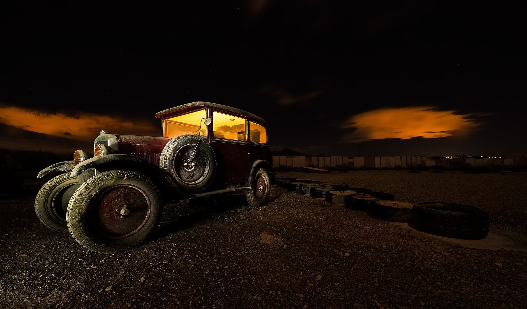 Old car at night with orange clouds HD Wallpaper