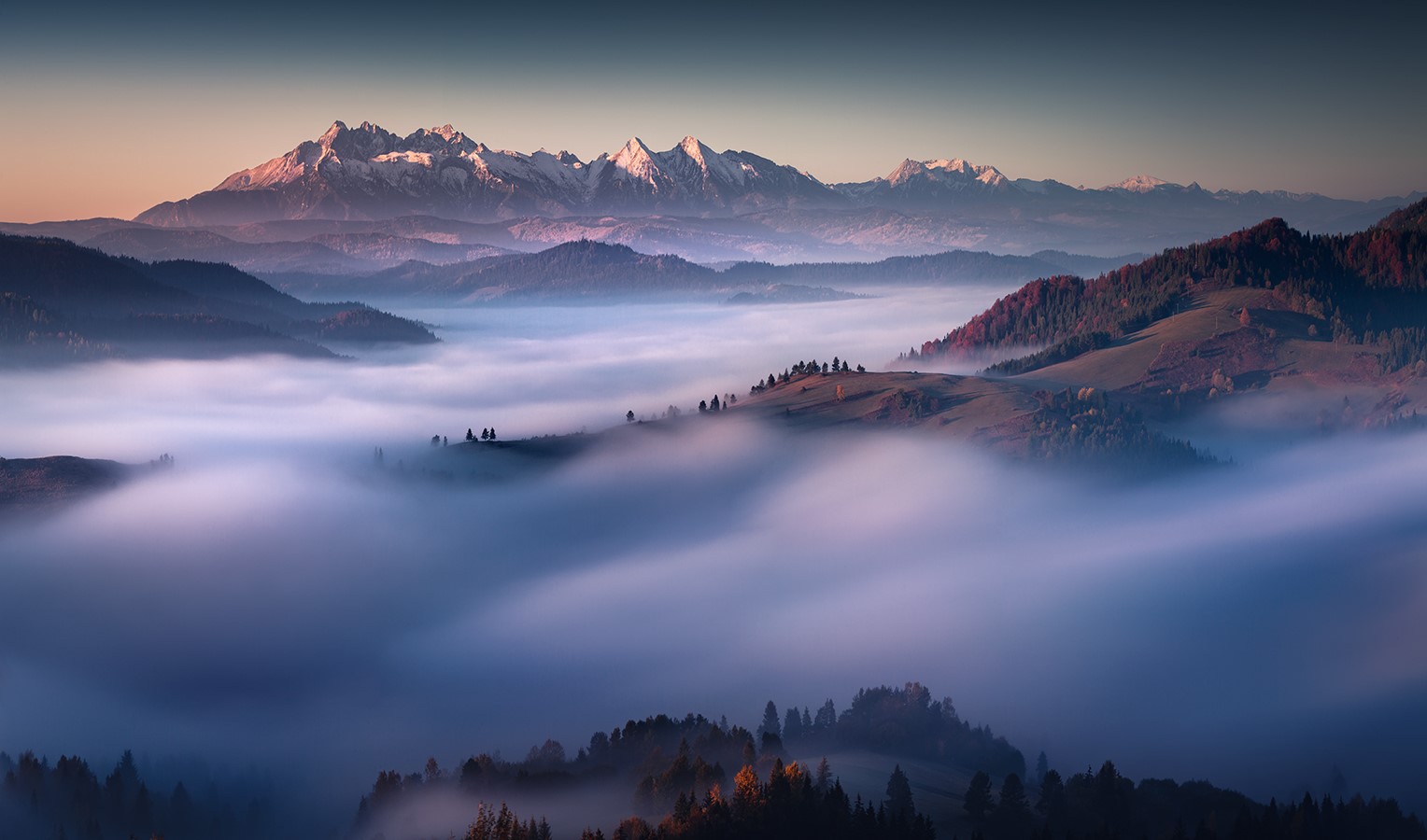 Misty mountain landscape at sunrise with snowy peaks HD Wallpaper