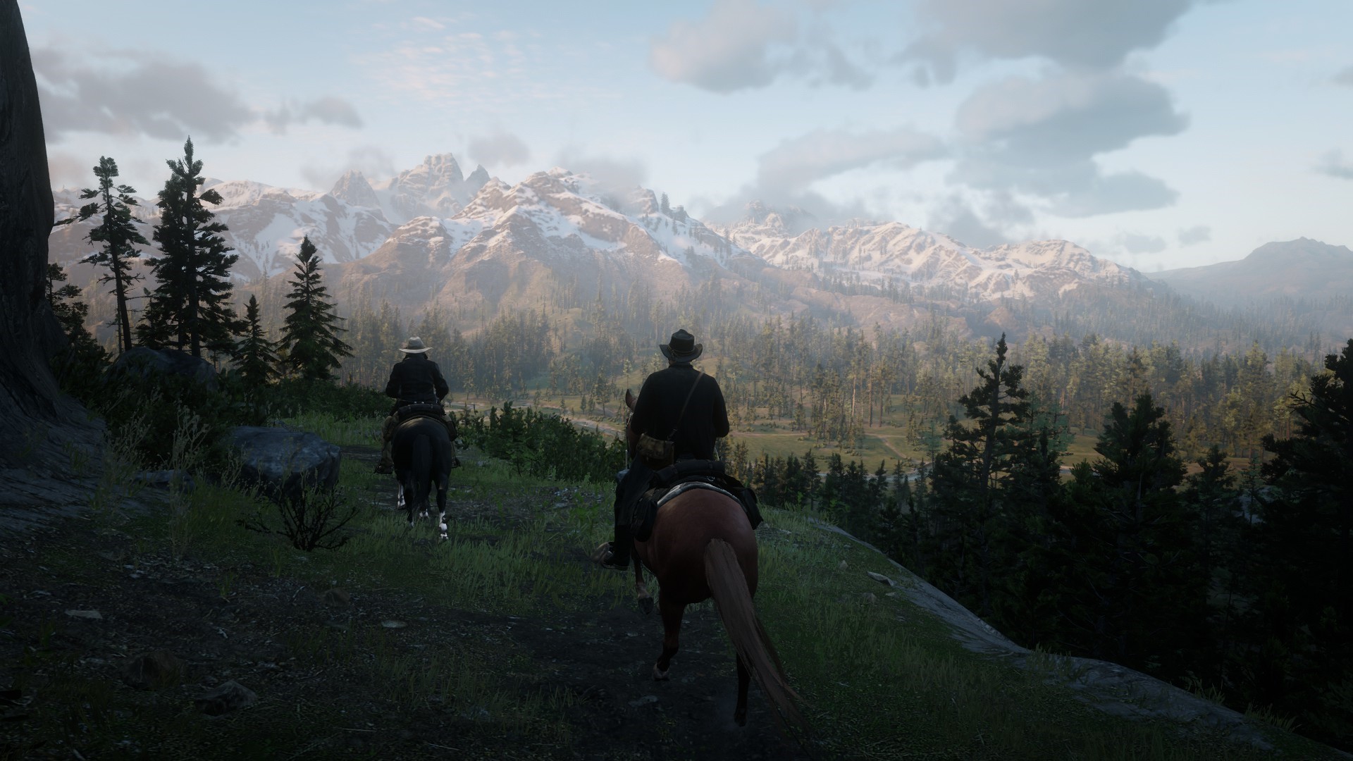 Two cowboys on horseback in Red Dead Redemption 2 with mountains HD Wallpaper