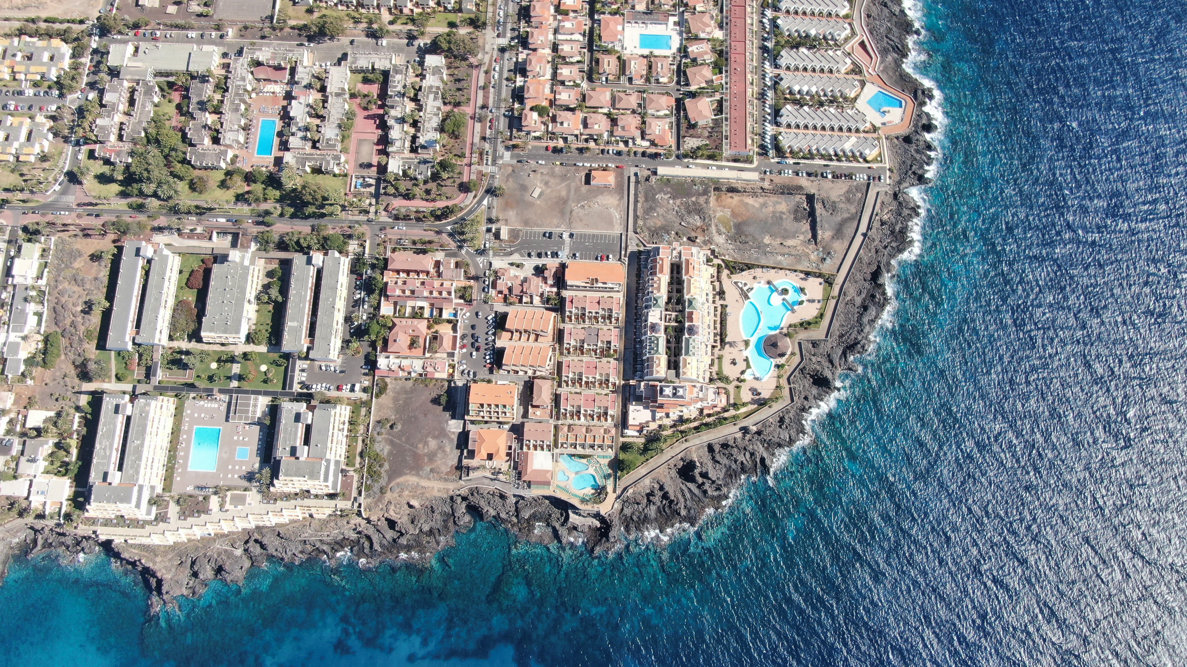 Aerial view of Tenerife coast with resorts and ocean HD Wallpaper