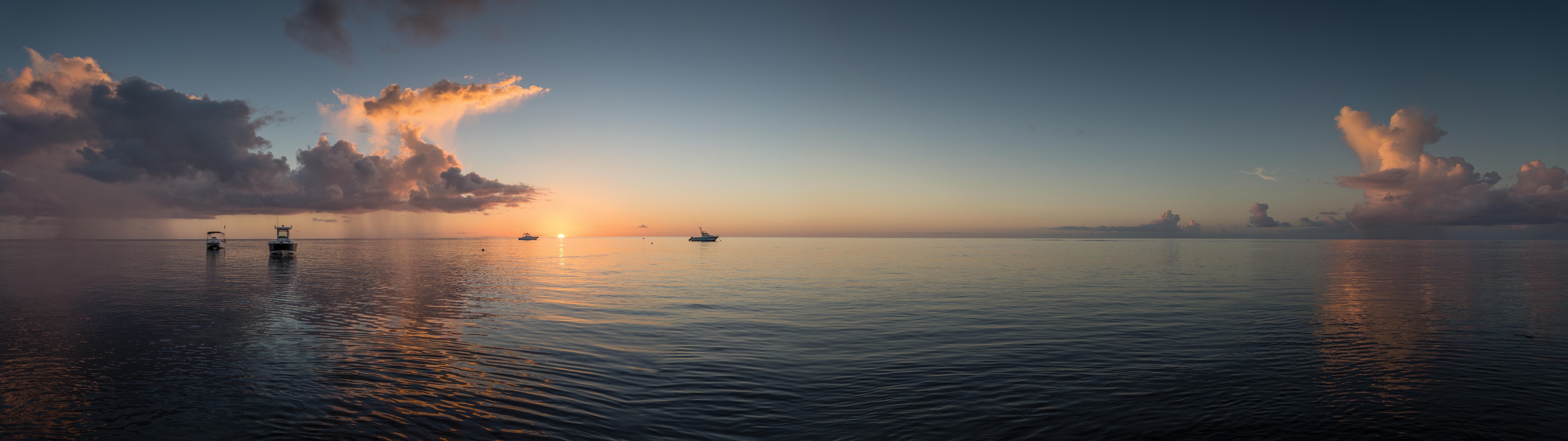 Panoramic sunset over the sea with boats and clouds HD Wallpaper