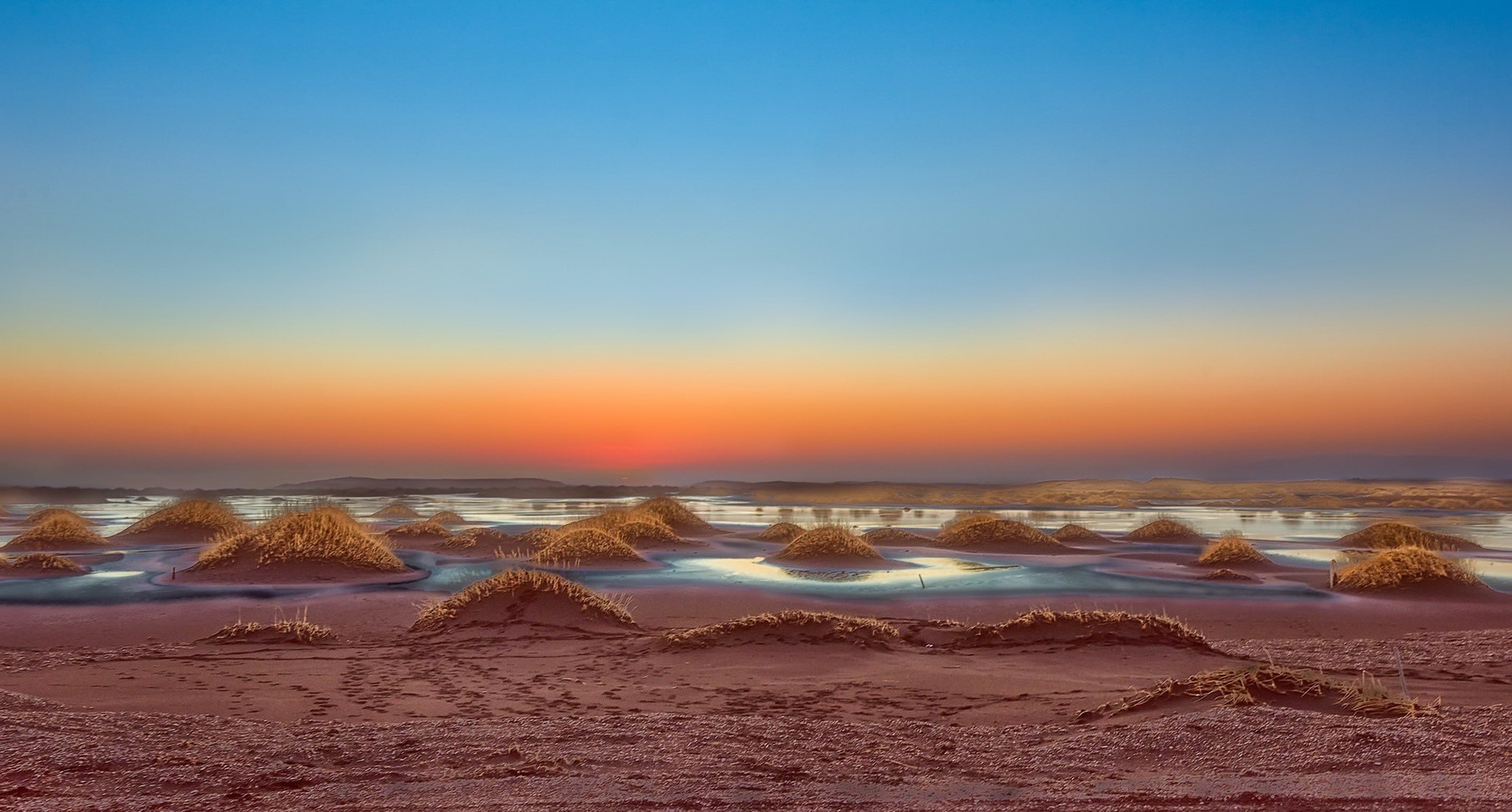 Desert landscape with mounds and sunset sky HD Wallpaper