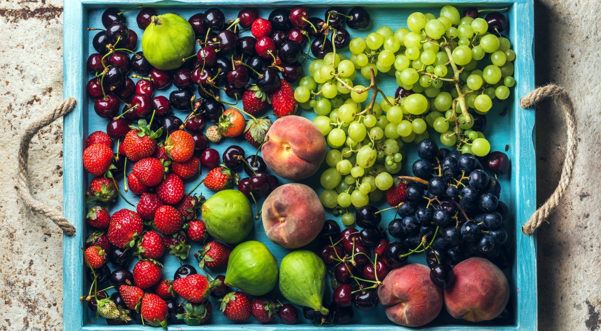 Colorful fruit platter with berries, grapes, peaches, and figs HD Wallpaper