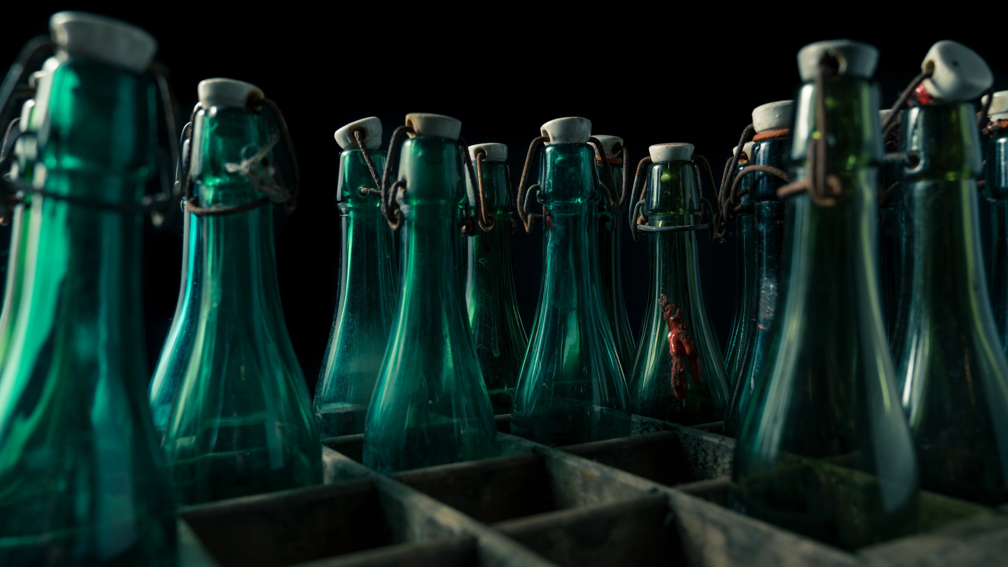 Green glass bottles with swing tops in a wooden crate HD Wallpaper