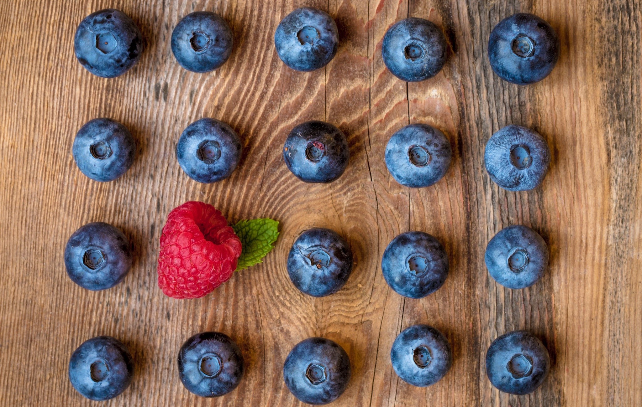 Blueberries and raspberries on a wooden surface HD Wallpaper