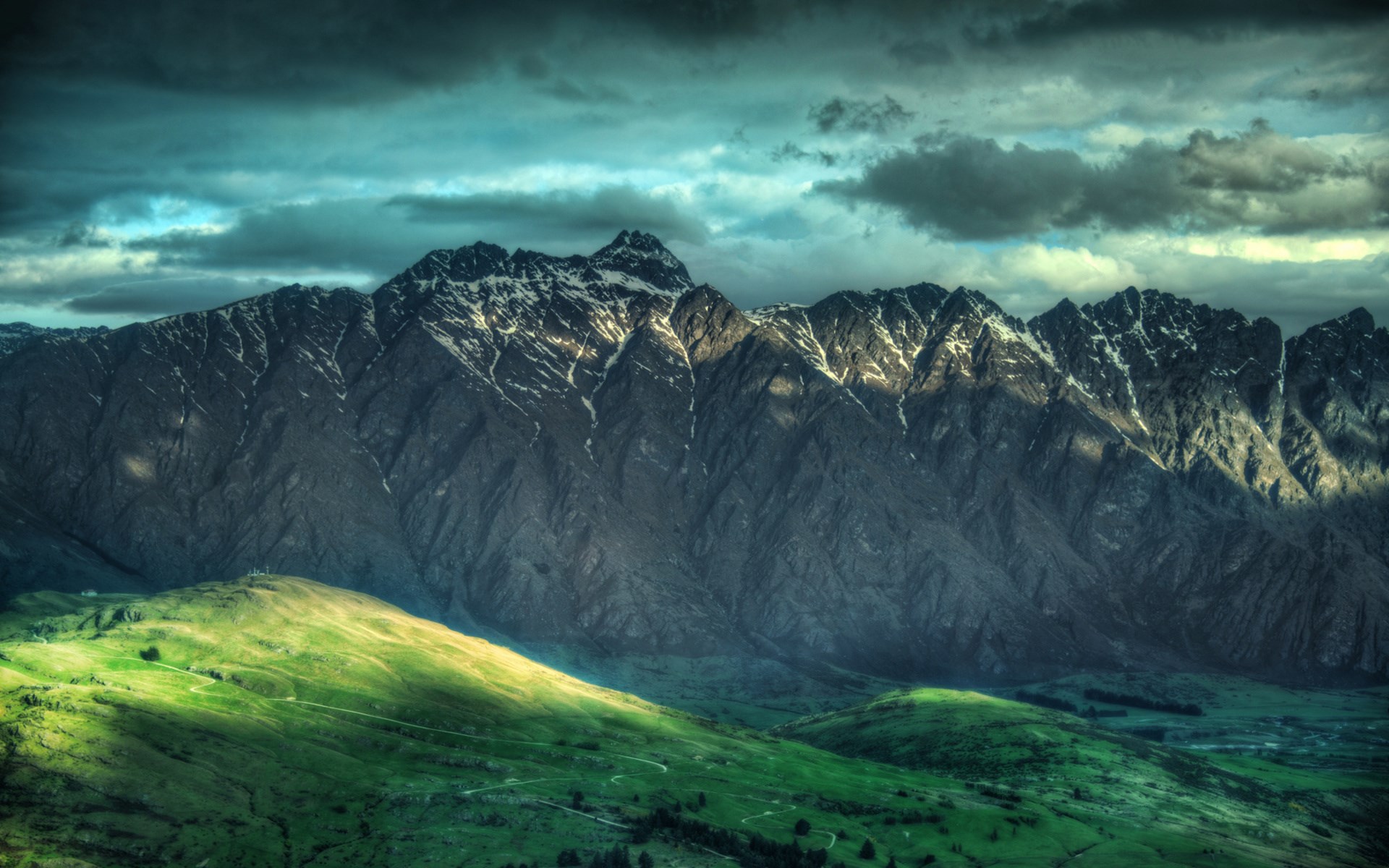 Mountain range with green hills and dramatic sky HD Wallpaper
