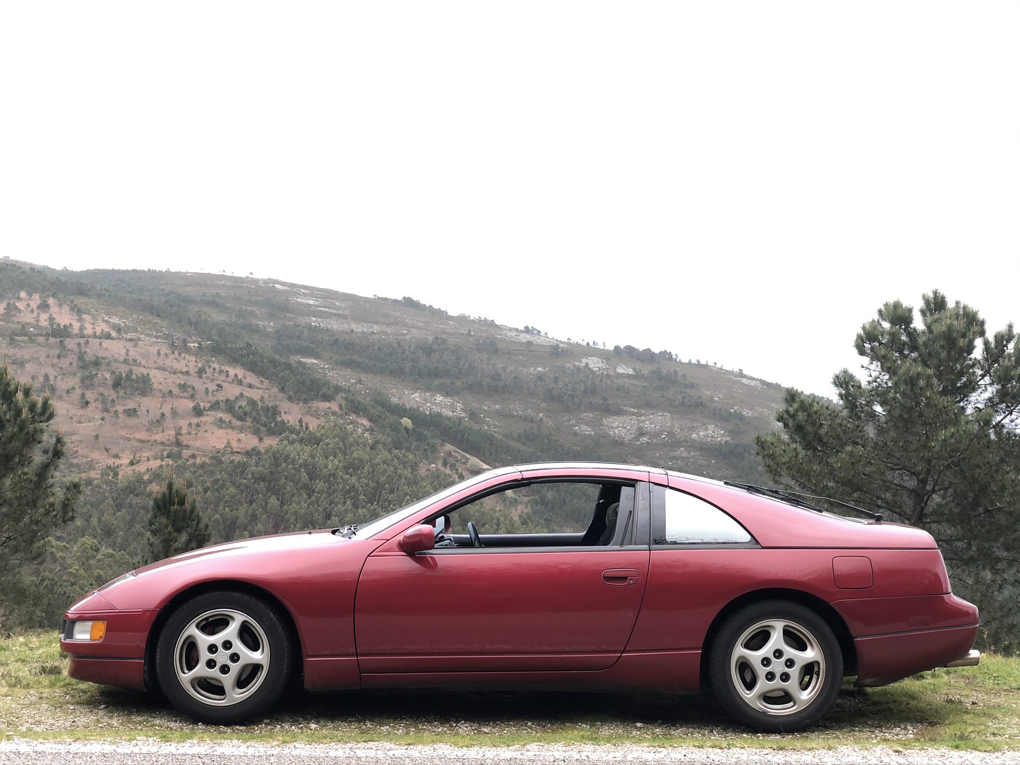 Red Nissan 300ZX parked on a hillside road HD Wallpaper