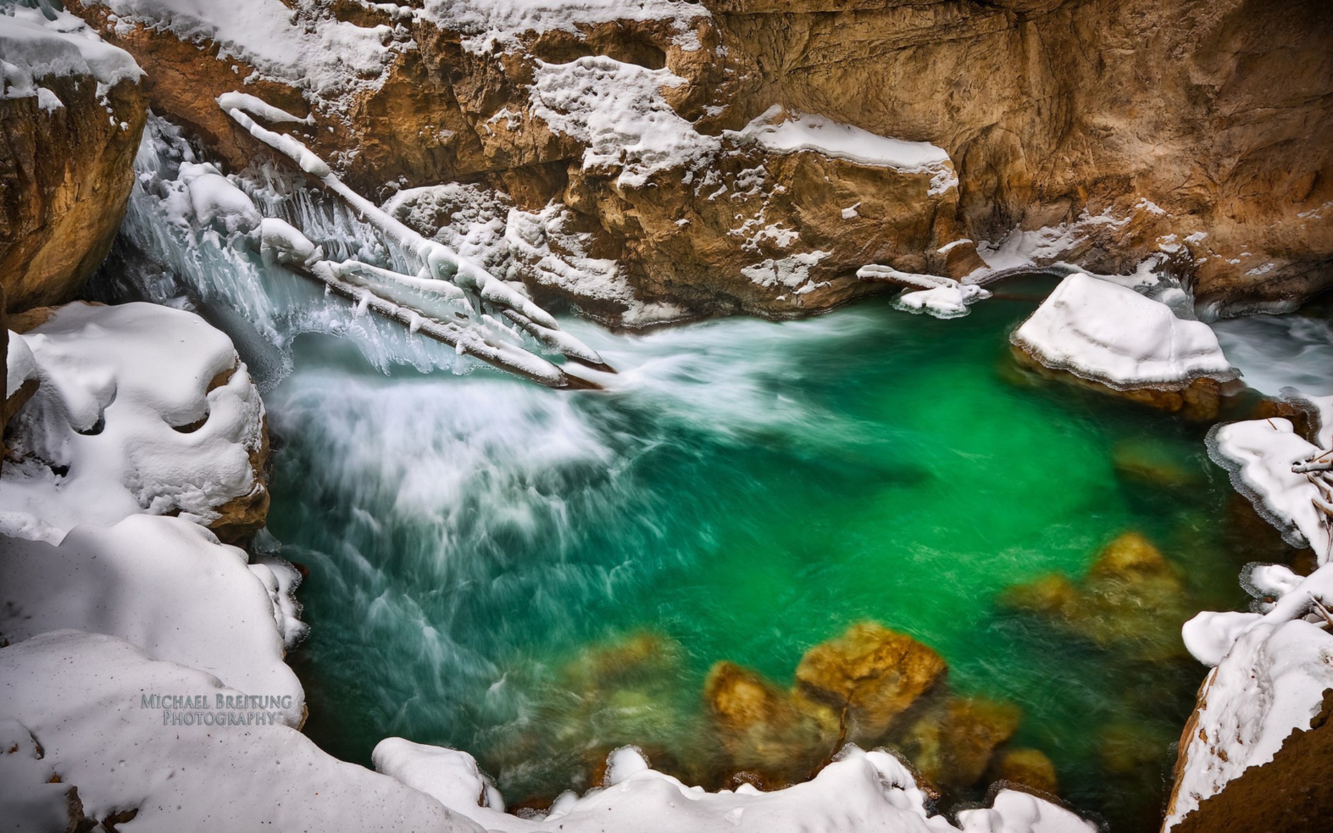Turquoise river flowing through a snowy gorge HD Wallpaper