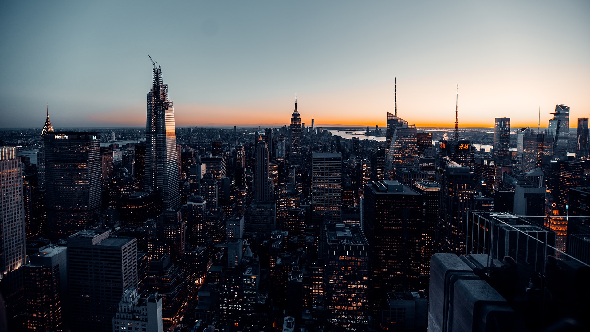 New York City skyline at sunset with lights HD Wallpaper