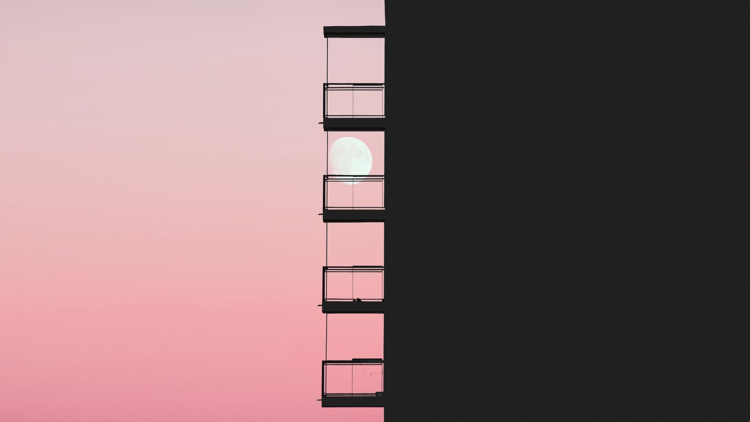Balconies on a building with the moon in the sky HD Wallpaper