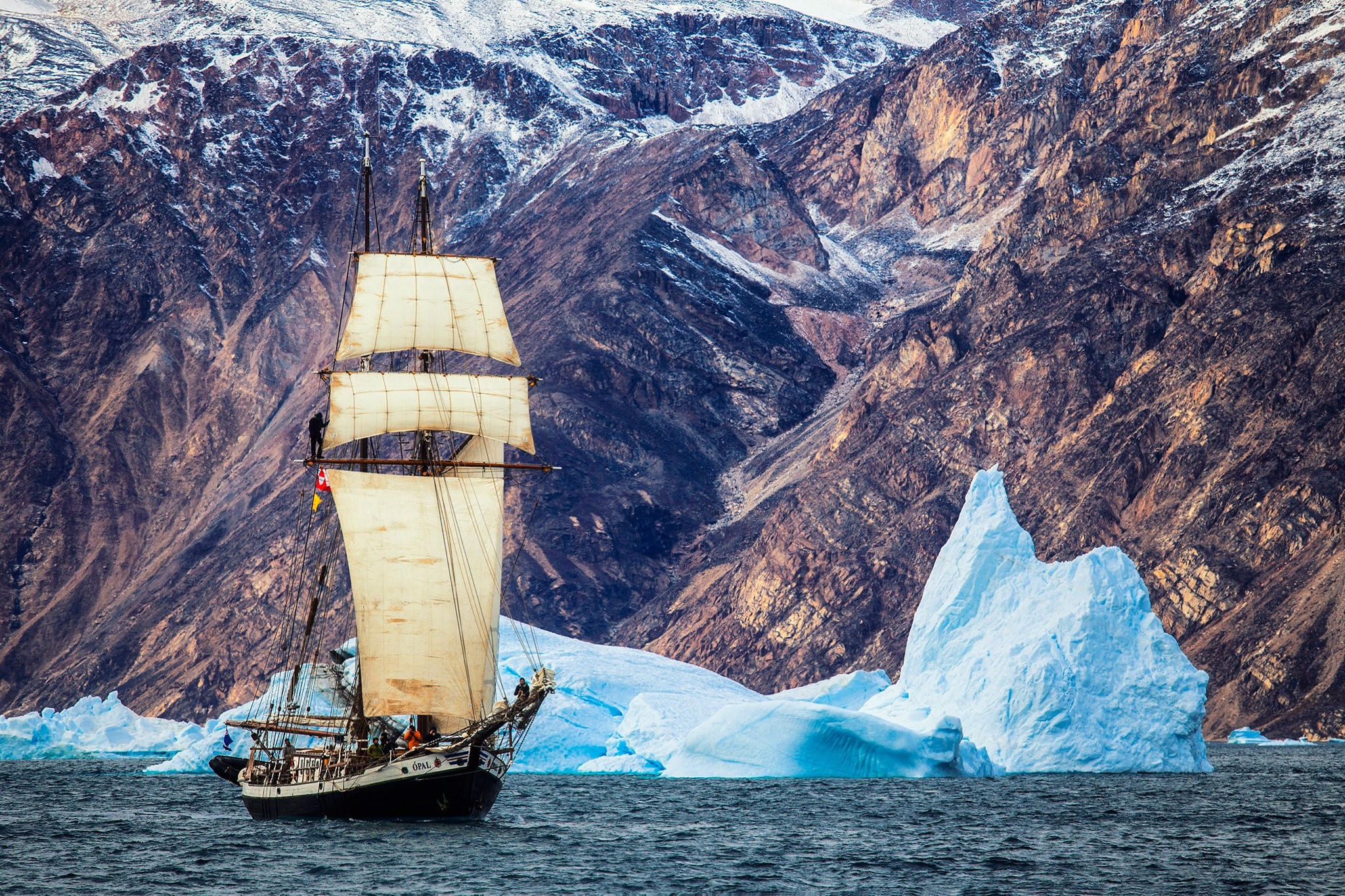 Sailing ship near icebergs and mountains in Greenland HD Wallpaper