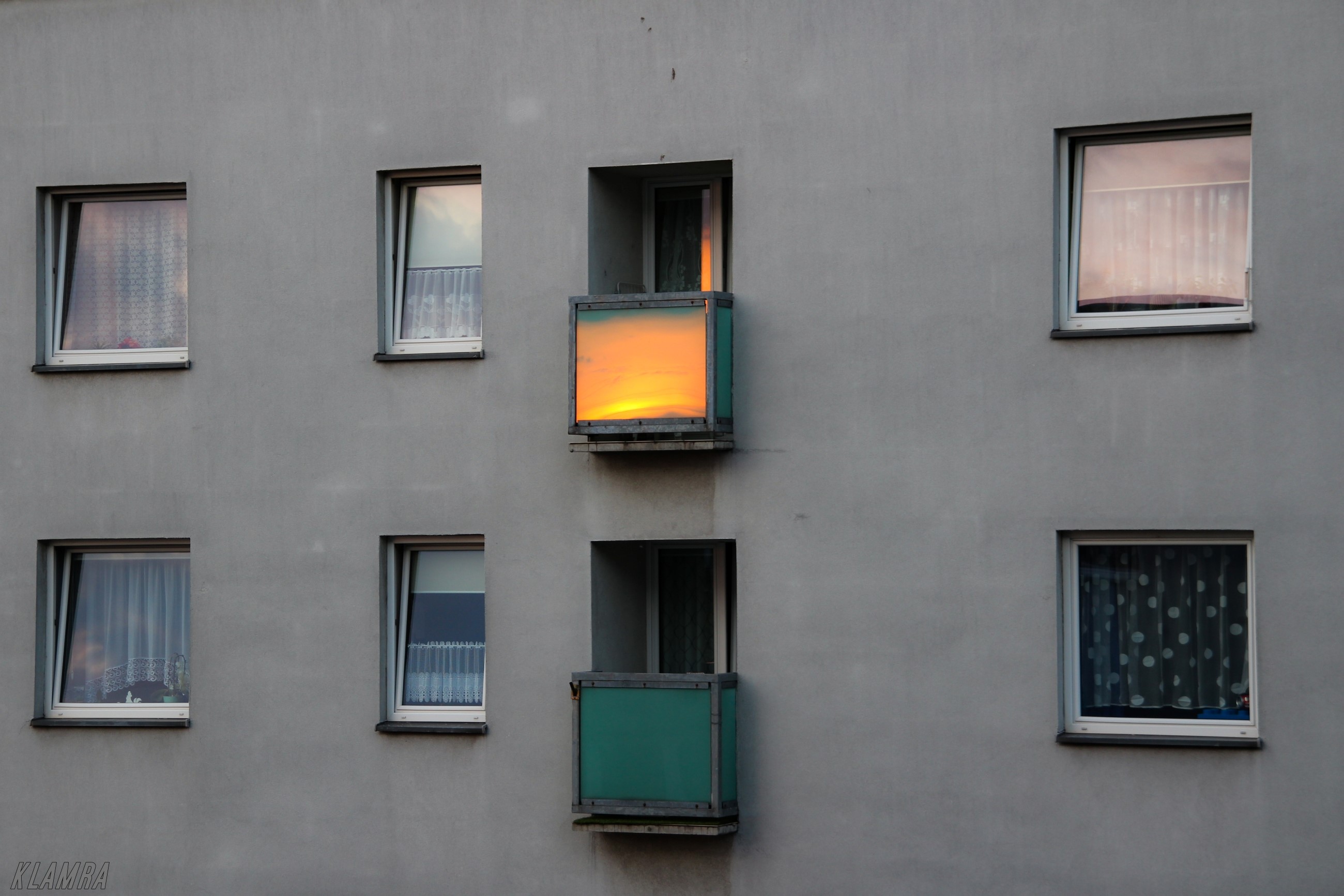 Apartment building with balconies and windows at sunrise HD Wallpaper