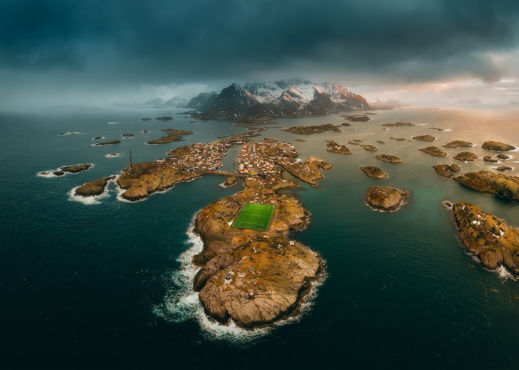 Aerial view of a village and soccer field in Lofoten, Norway HD Wallpaper