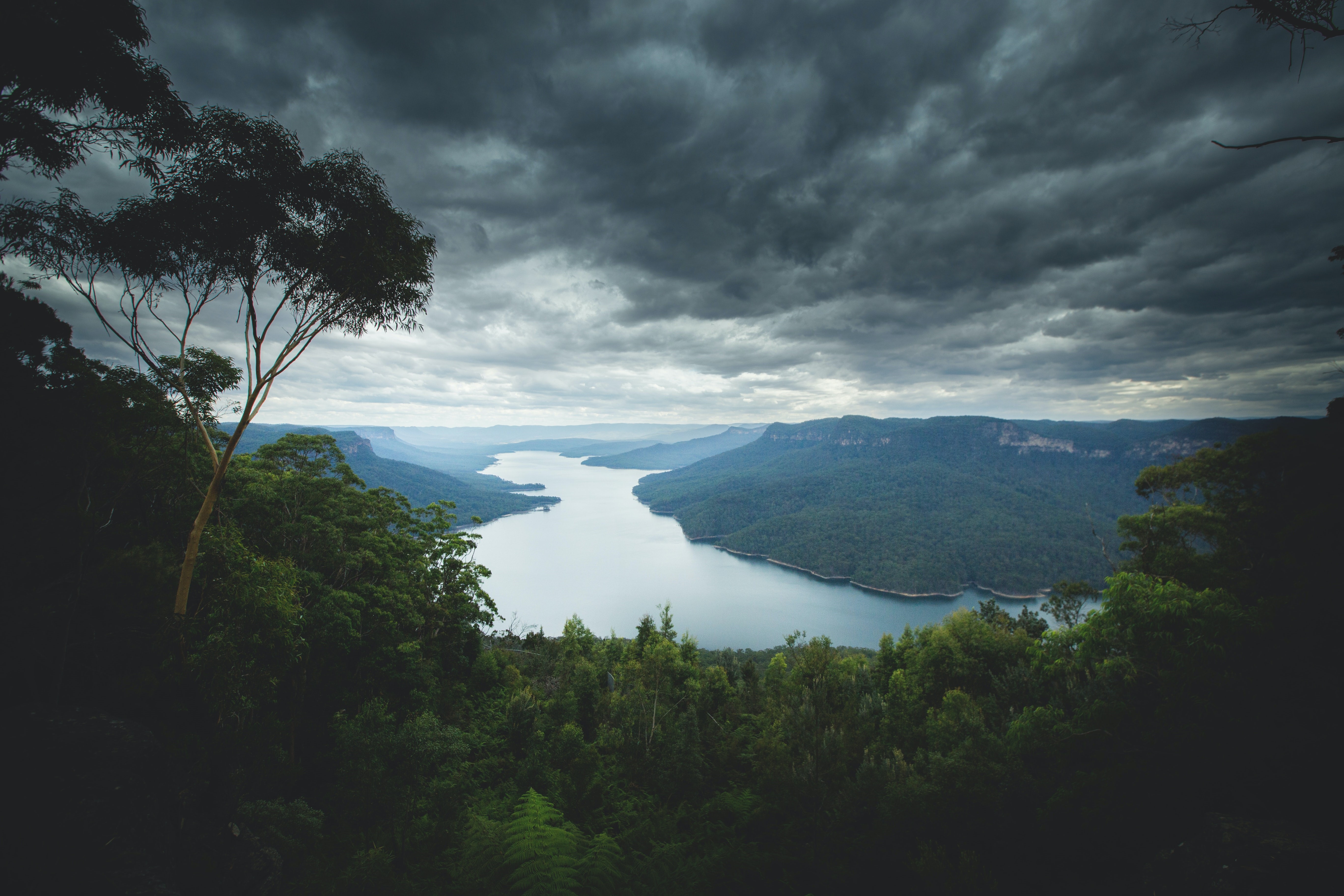 River valley with mountains and stormy clouds HD Wallpaper